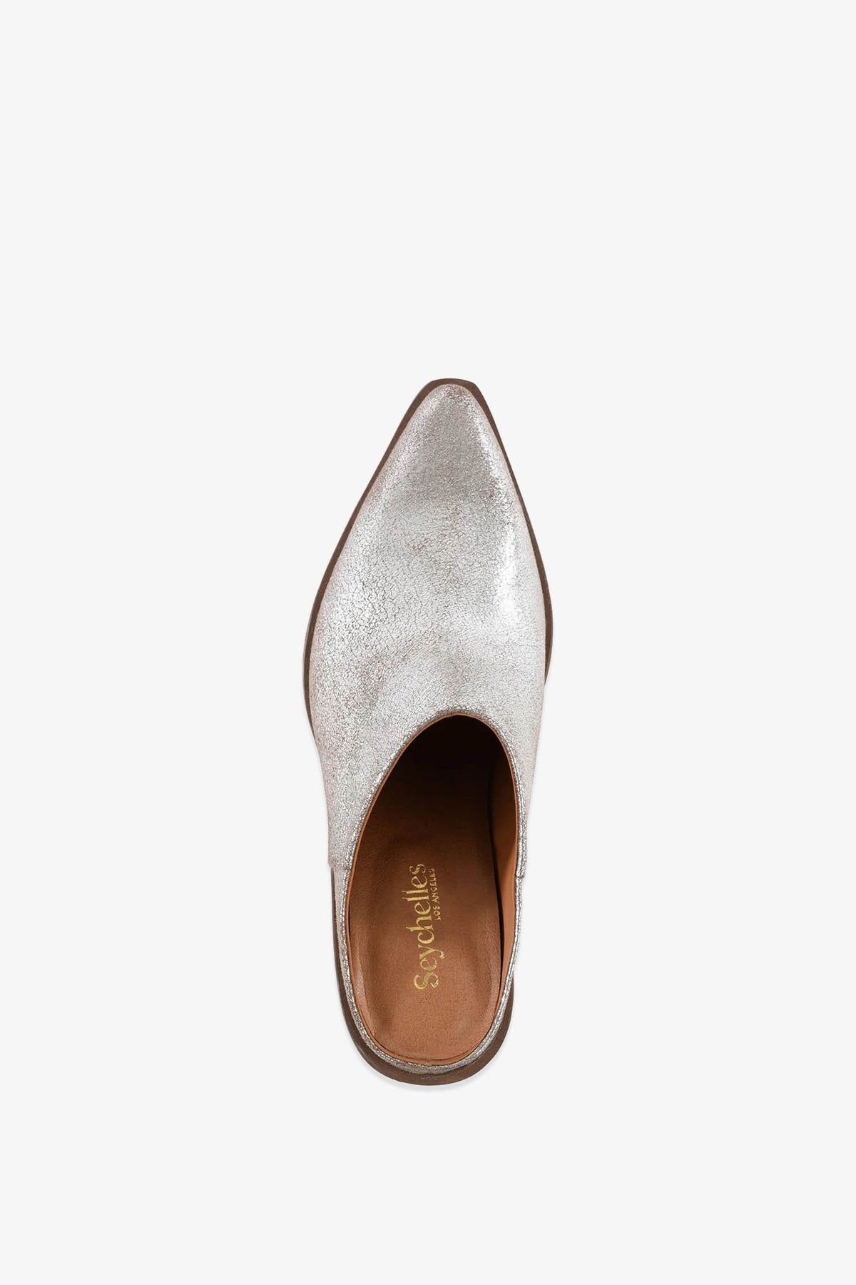 A metallic silver Morning Joe Mule slip-on shoe with a pointed toe and tan insole, viewed from above against a white background. The brand Seychelles is printed on the insole in gold lettering.
