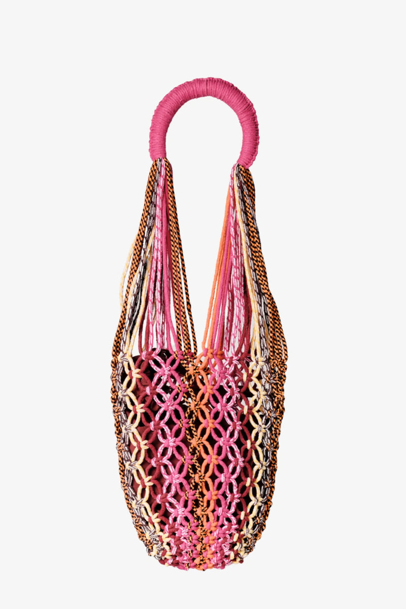 The Nannacay Kim Woven Bag is a colorful, handwoven net bag with a round, wrapped handle. It features interlaced threads in pink, orange, brown, and cream that create a striking lattice pattern.