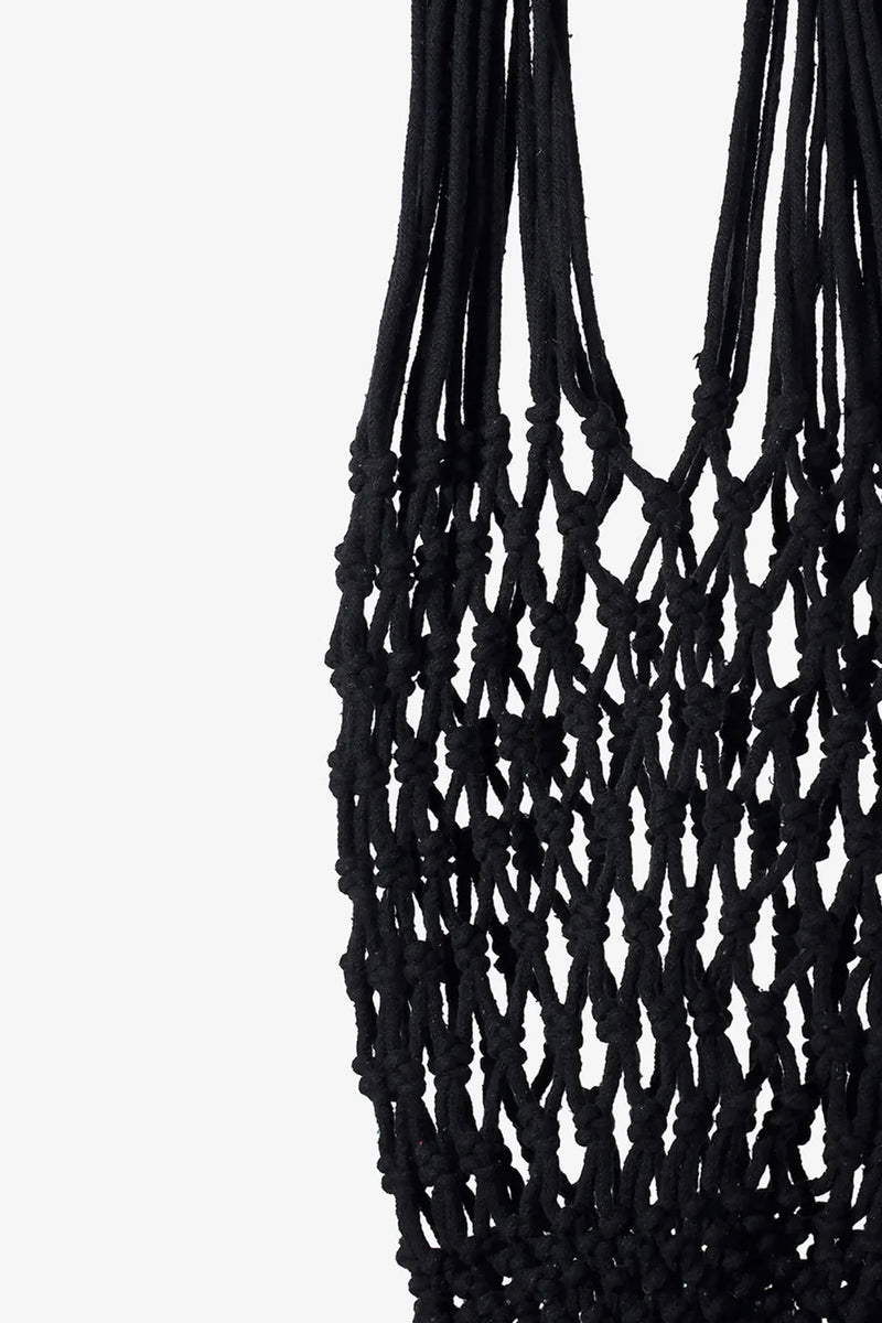 Close-up of the Nannacay Kim Woven Bag in black, featuring intricate knotted macramé cord patterns and loops against a white background.
