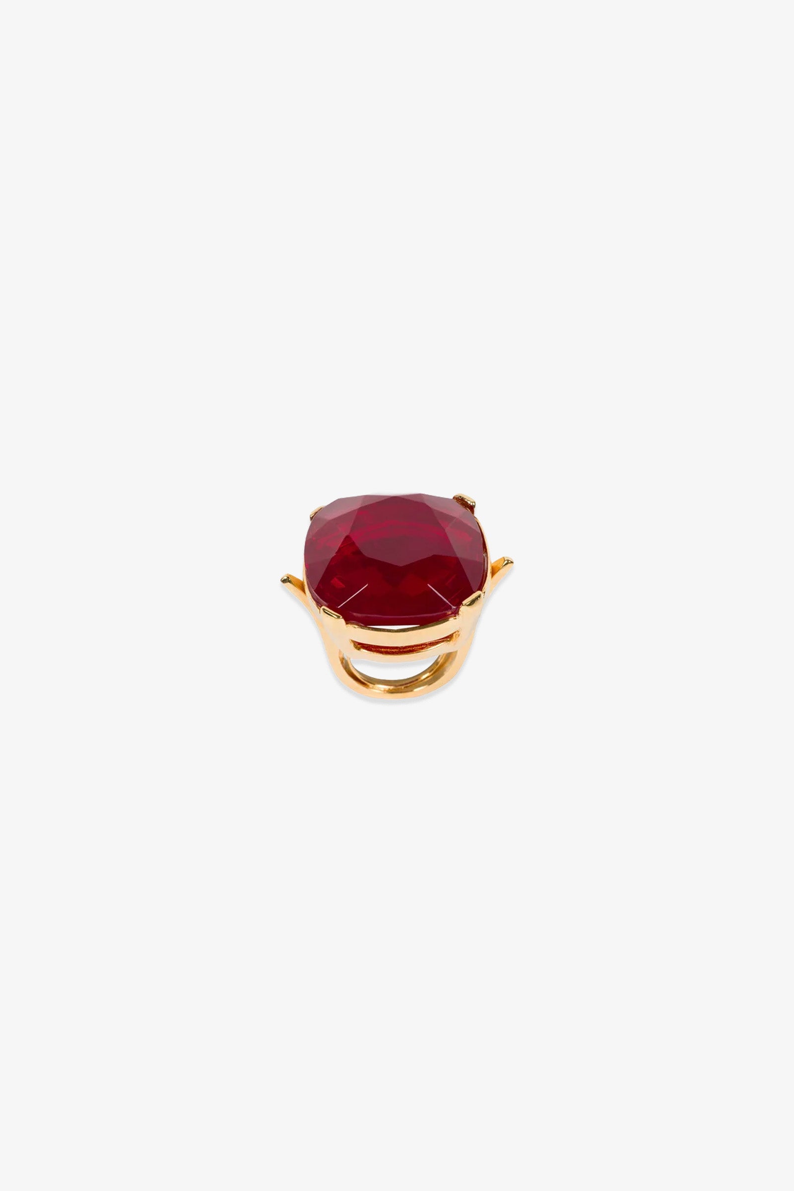A Ruby Faceted Cocktail Ring featuring a large, oval-shaped red gemstone set in the center, displayed on a plain white background.