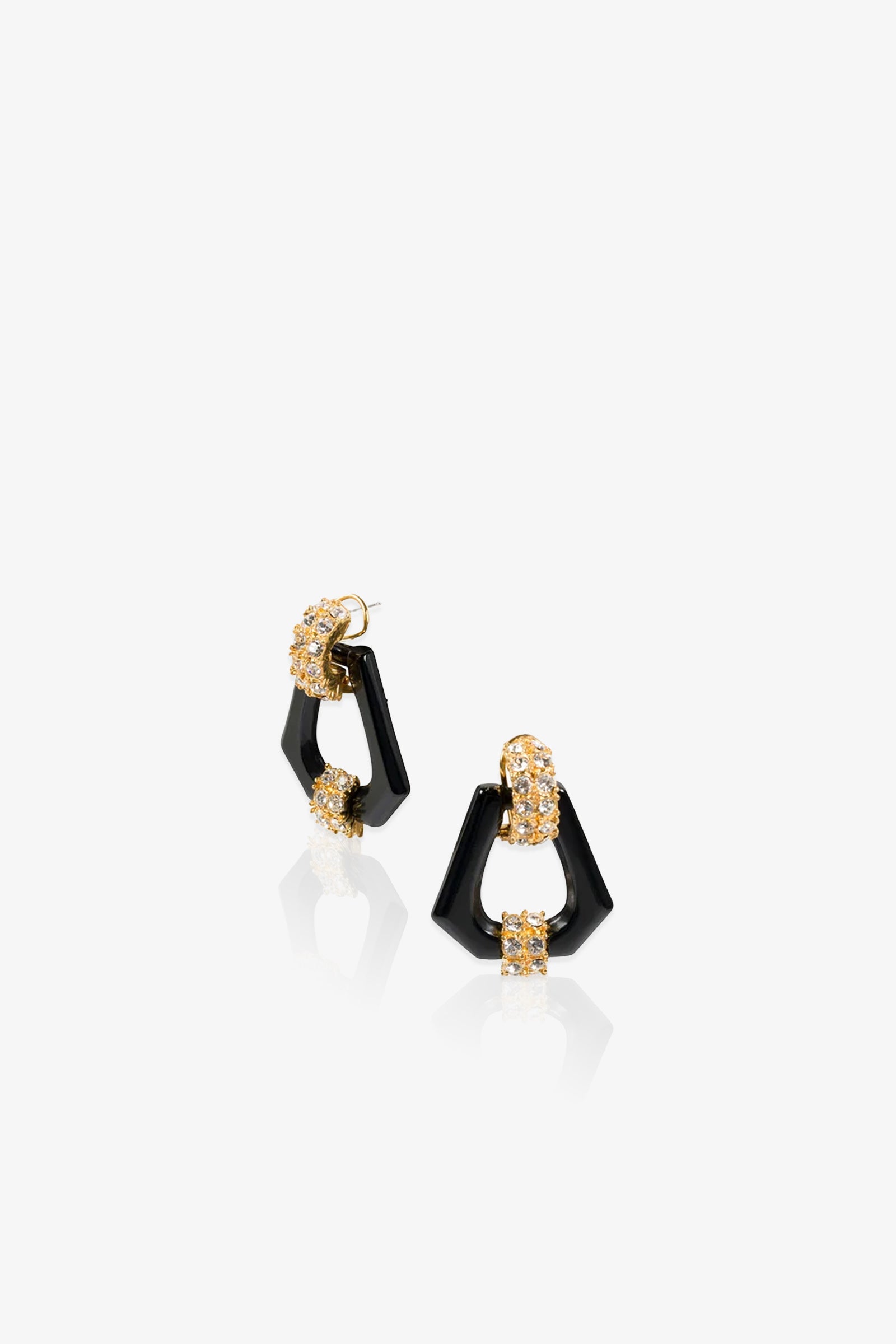 A pair of Hexagon Doorknocker Earrings featuring black angular shapes accented with gold and clear crystals, displayed on a white background.