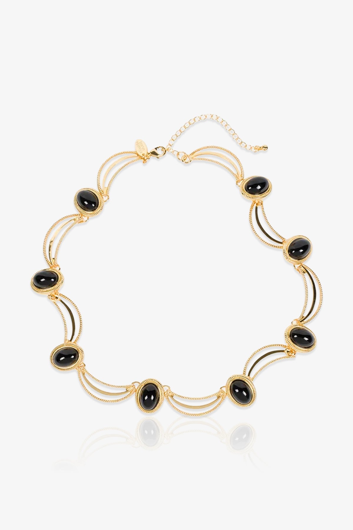 Oval Jet Scallop Necklace featuring oval black stones evenly spaced along a delicate gold chain, connected by scalloped gold arcs and links, finished with an adjustable clasp and a small gold tag.