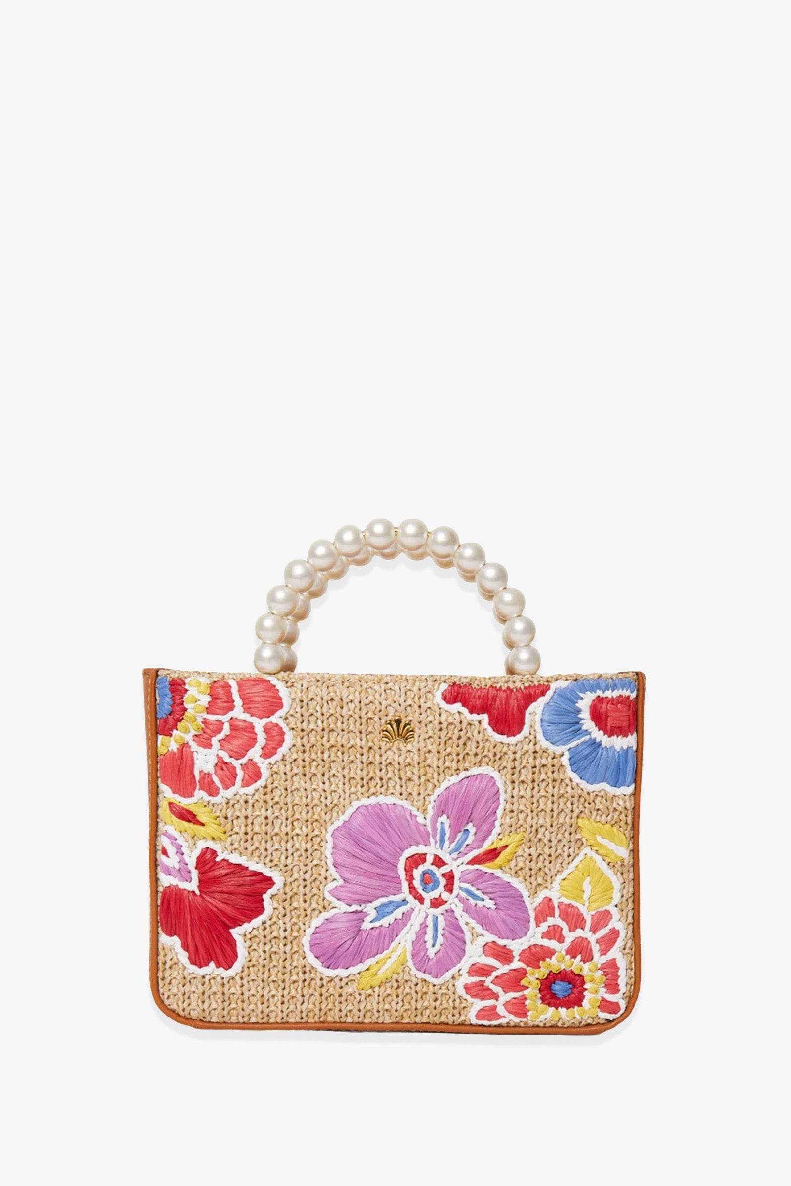 The Lele Sadoughi x Trina Turk Maya Floral Mini Tote is a woven straw handbag adorned with colorful embroidered flowers and features a handle crafted from large faux pearls, shown against a white background.