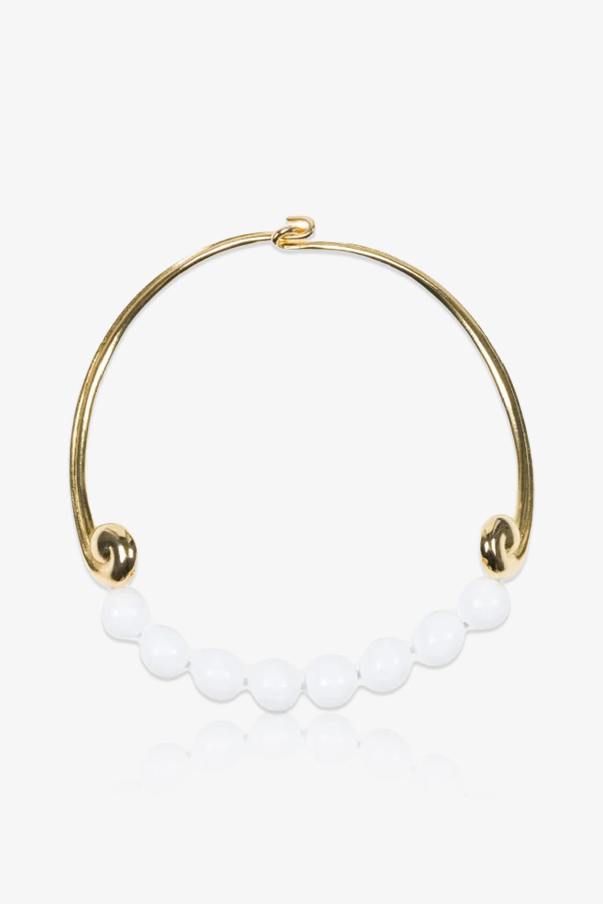 The KJL Beaded White and Gold Collar Necklace features a row of round white beads along its graceful gold curve, finished with decorative loops at each end.