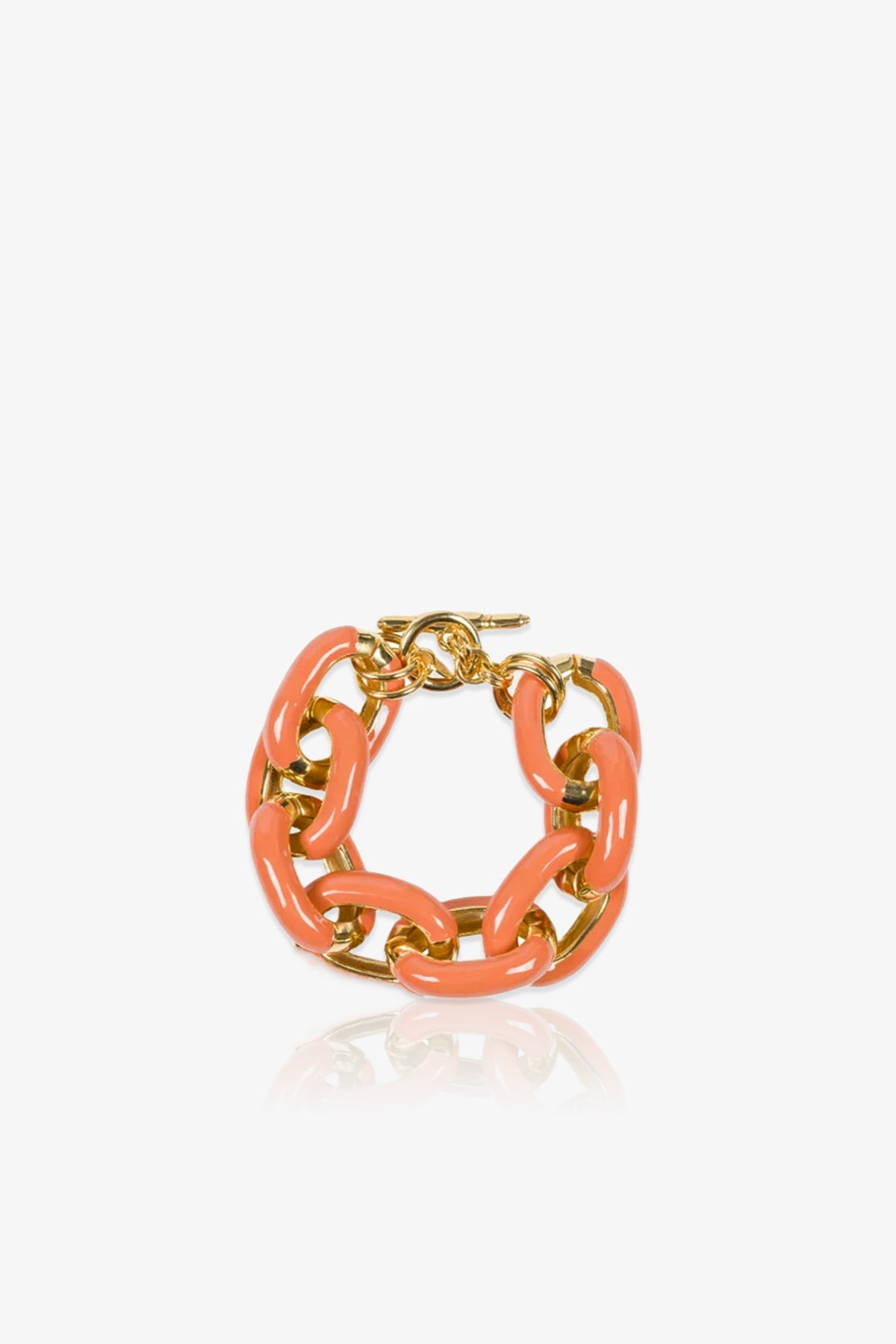 The TT x KJL Enamel Link Bracelet - Coral features large, glossy coral pink and gold chain links with a gold toggle clasp, beautifully displayed on a white reflective surface.