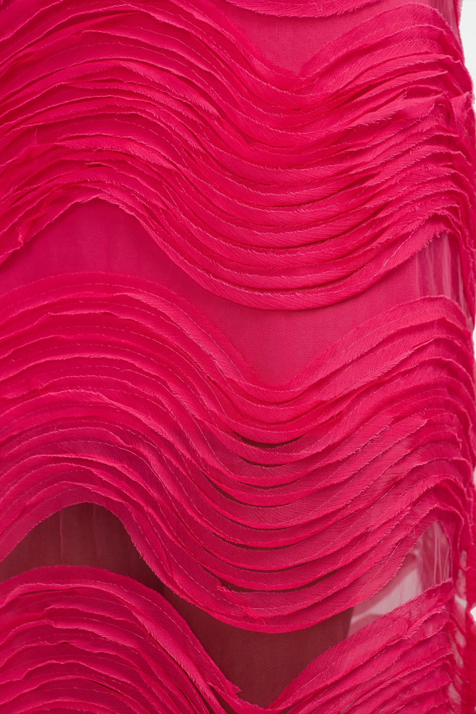 Close-up of the Belisama Organza Midi Dress in bright pink, featuring wavy, layered textures that create a three-dimensional effect and soft, sheer sections between the textured waves.