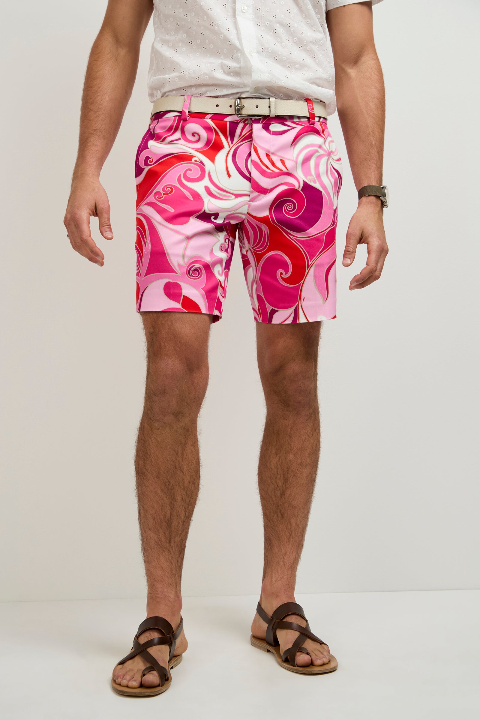 A person stands against a plain white background wearing a white short-sleeve shirt, tan belt, Lawrence Short - Darsena in MULTI, brown sandals, and a wristwatch. Their face is not visible.