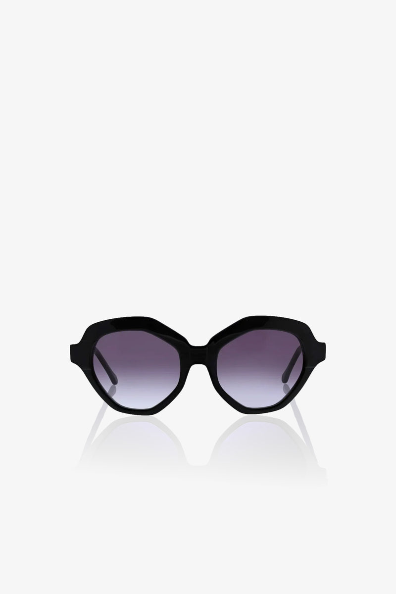 The Ipanema Sunglasses feature a black oval-shaped design with thick frames and dark tinted lenses, showcased facing forward on a plain white background.