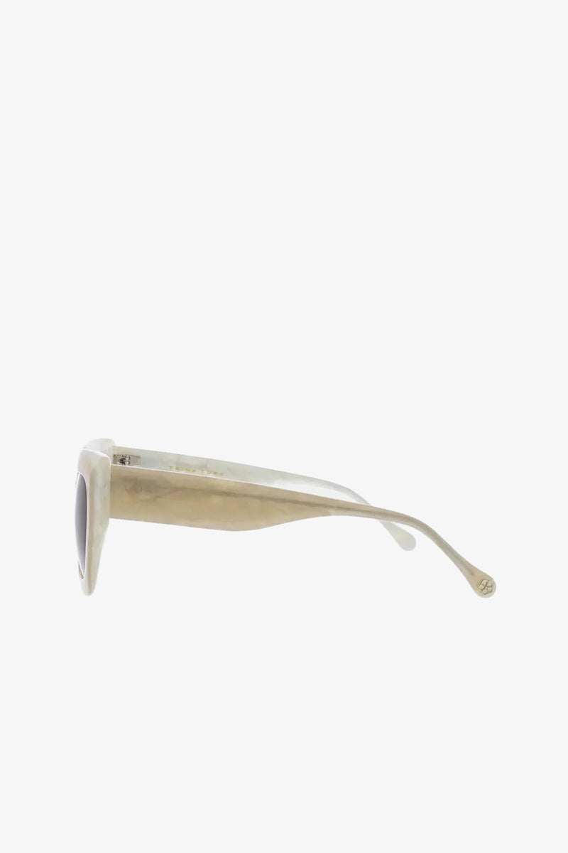 Side view of Sol Sunglasses in beige or light tan with dark lenses, featuring thick arms and a subtle logo on the temple tip, shown against a plain white background.