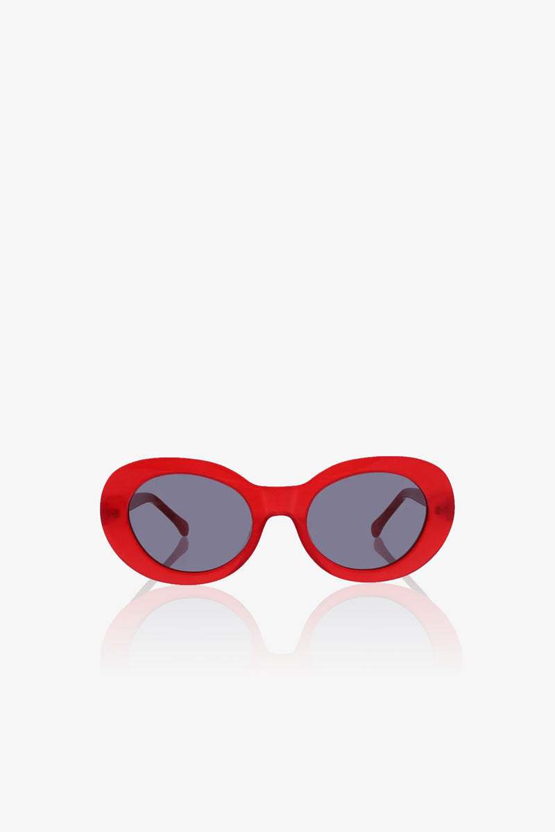Carova Oval Sunglasses featuring a bold, glossy red frame and dark lenses are displayed on a white background. The distinctive oval design allows the arms of the glasses to be seen through the lenses.