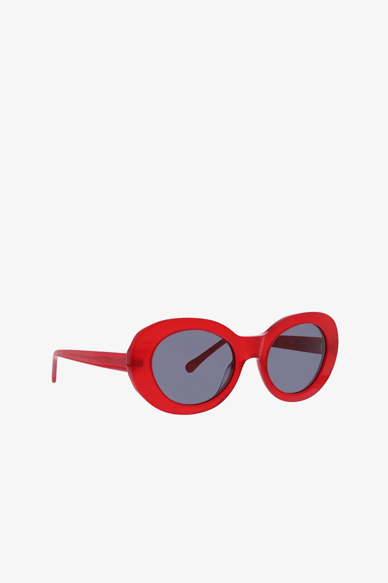 Carova Oval Sunglasses in red, featuring dark lenses and displayed at an angle on a plain white background.