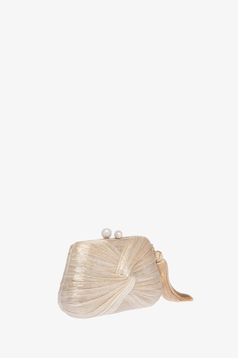 The Rosie Draped Clutch is a small beige bag with a textured, wrapped design, a decorative knot on one side, and a clasp closure topped with two pearl-like spheres.