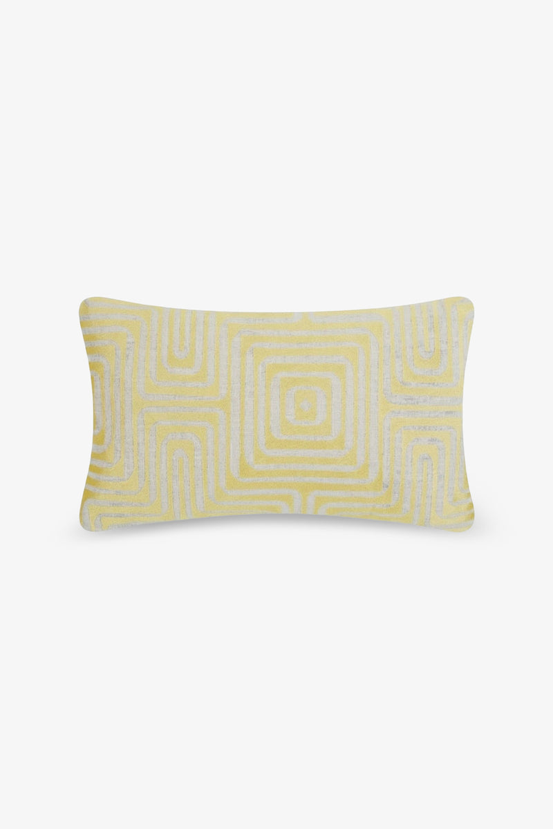 The Amazing Maze Embroidered Lumbar Pillow features a white and yellow geometric pattern of concentric squares, showcased against a plain white background.