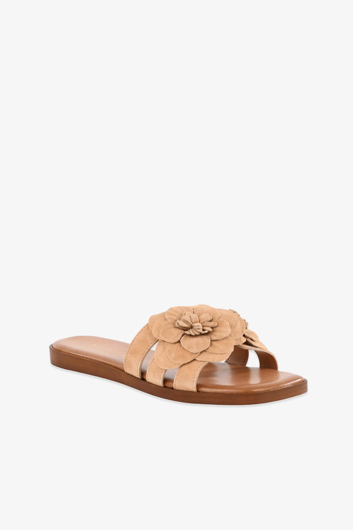 Morning Dew Slide: tan flat sandal featuring three straps and a large decorative flower on the top strap, displayed against a white background.