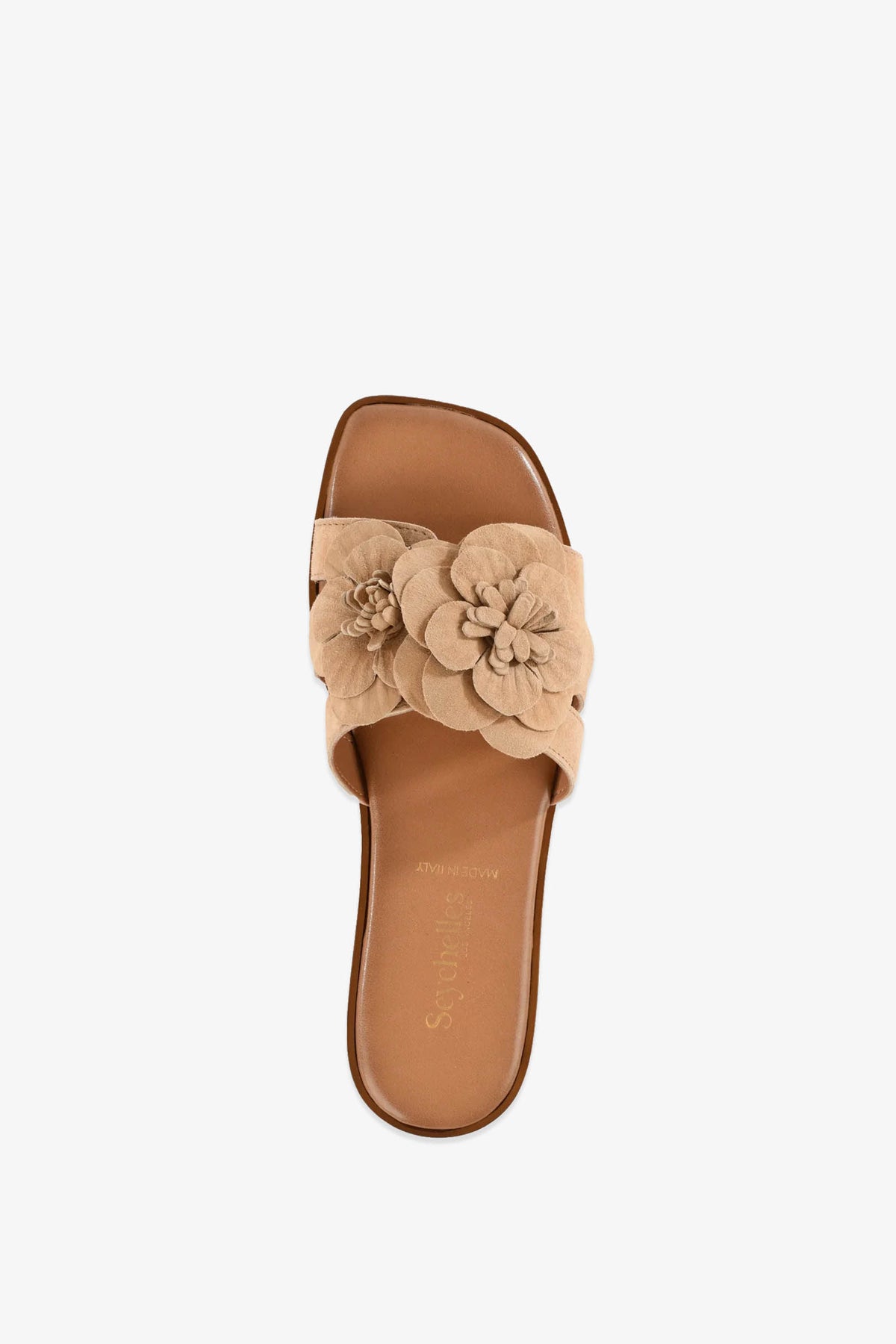 Introducing the Morning Dew Slide: a beige slide sandal featuring a wide strap adorned with two layered fabric flowers on top. This sandal showcases an open toe design, a tan cushioned footbed, and a flat sole for all-day comfort.