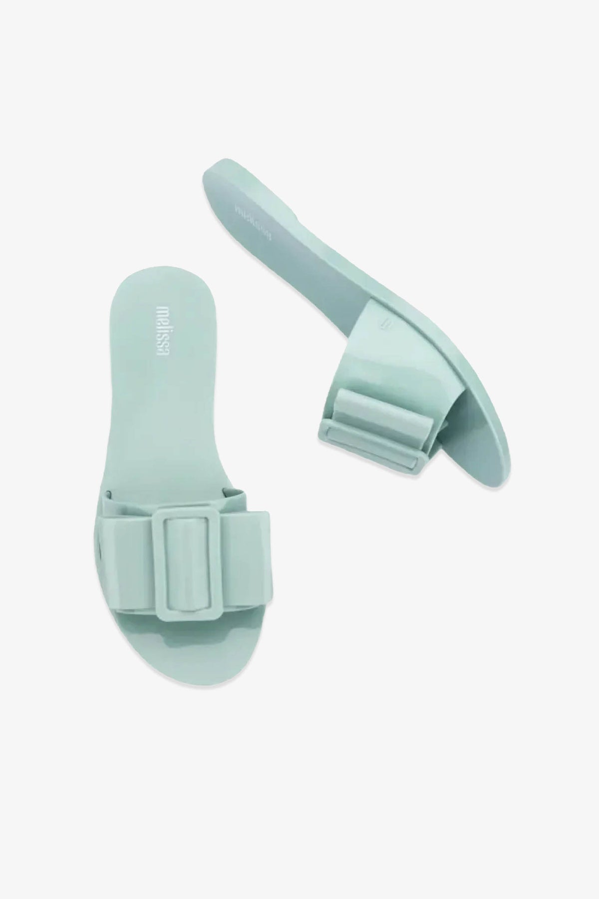 Two mint green Babe Sandals with wide straps featuring large, rectangular decorative bows, displayed on a plain white background.