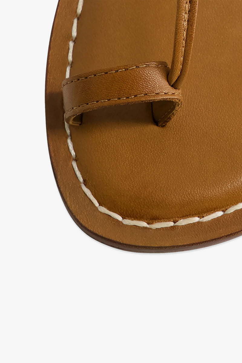 Close-up of the toe area of the Maverick 2 Sandal, featuring brown leather with white stitching and a leather loop designed for the big toe.