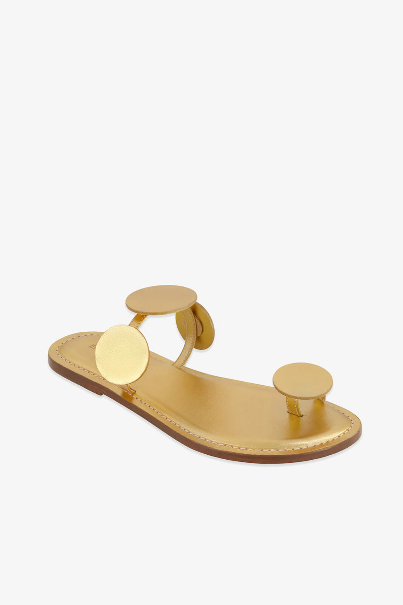 New Moon Sandal in gold, featuring circular gold accents on the toe and strap, a leather sole, and an open back, displayed against a white background.