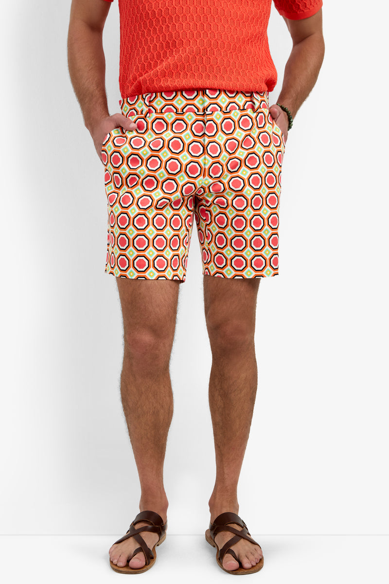 Wearing the Lawrence Short - Salerno Herringbone, a man stands with hands in pockets. Only his body from the shoulders down is visible.