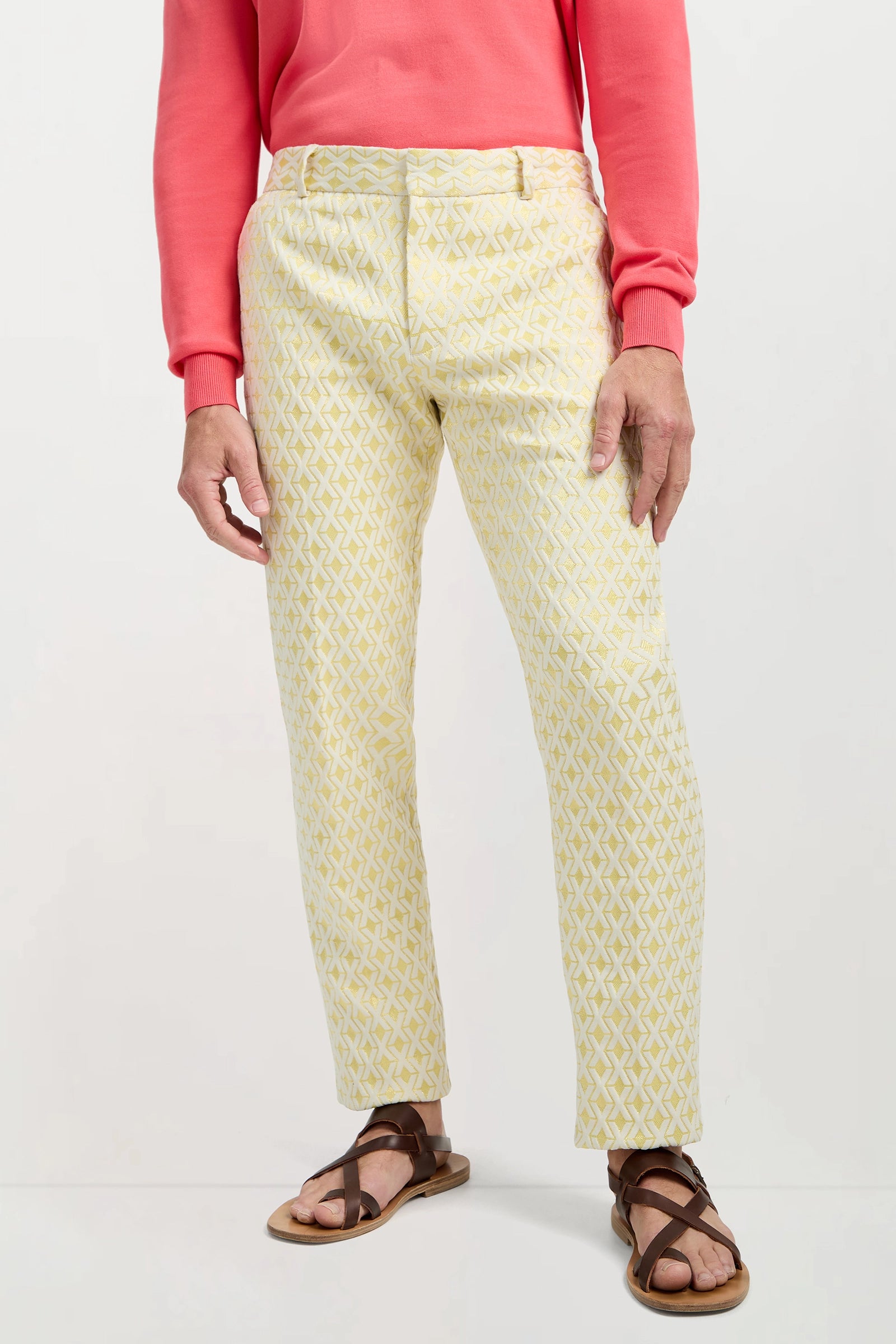 A person wearing the Clyde Slim Trouser - Crossroads Jacquard stands against a plain light background, with only the lower half of their body visible.