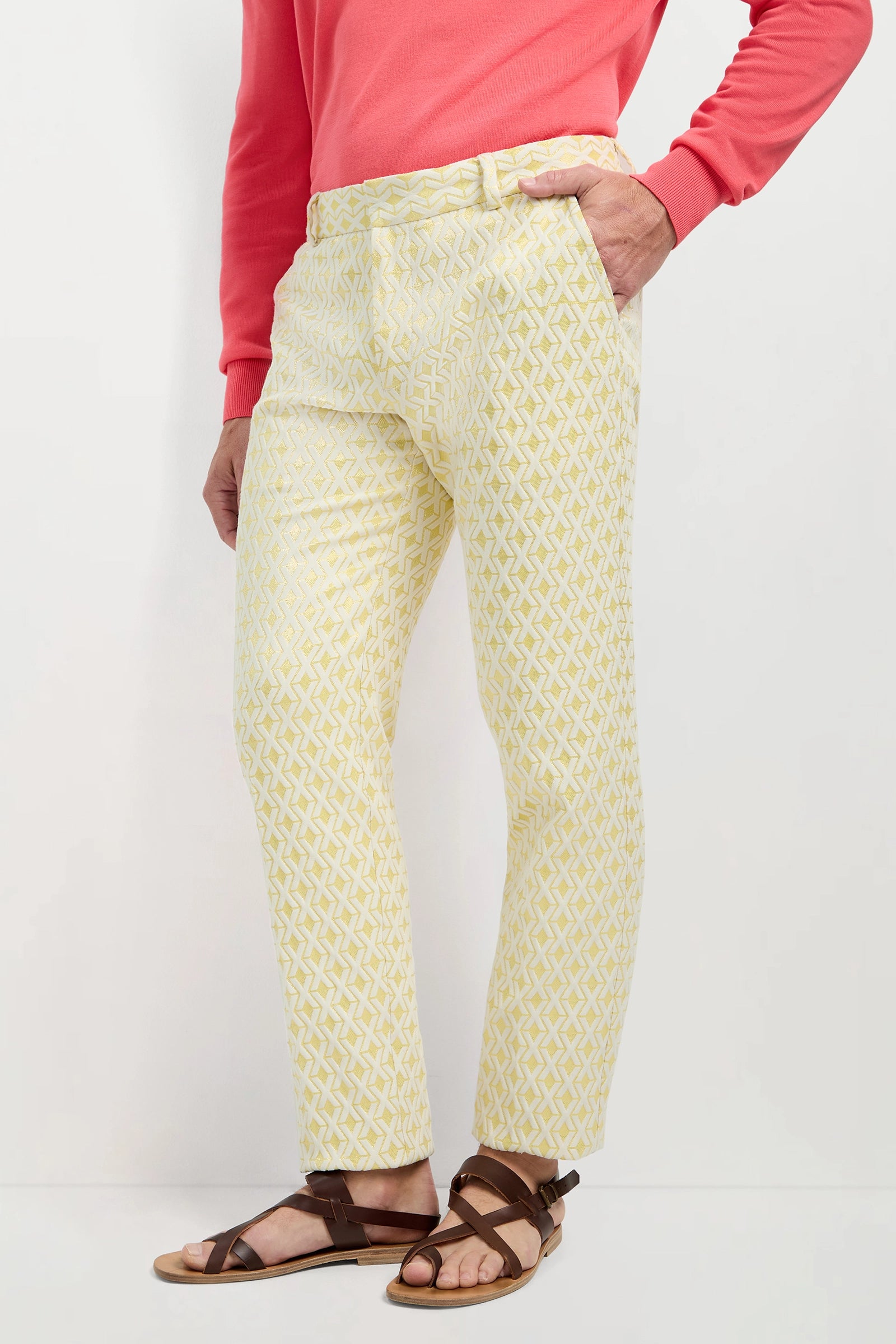 A person wearing the Clyde Slim Trouser - Crossroads Jacquard stands against a plain white background with one hand in their pocket.