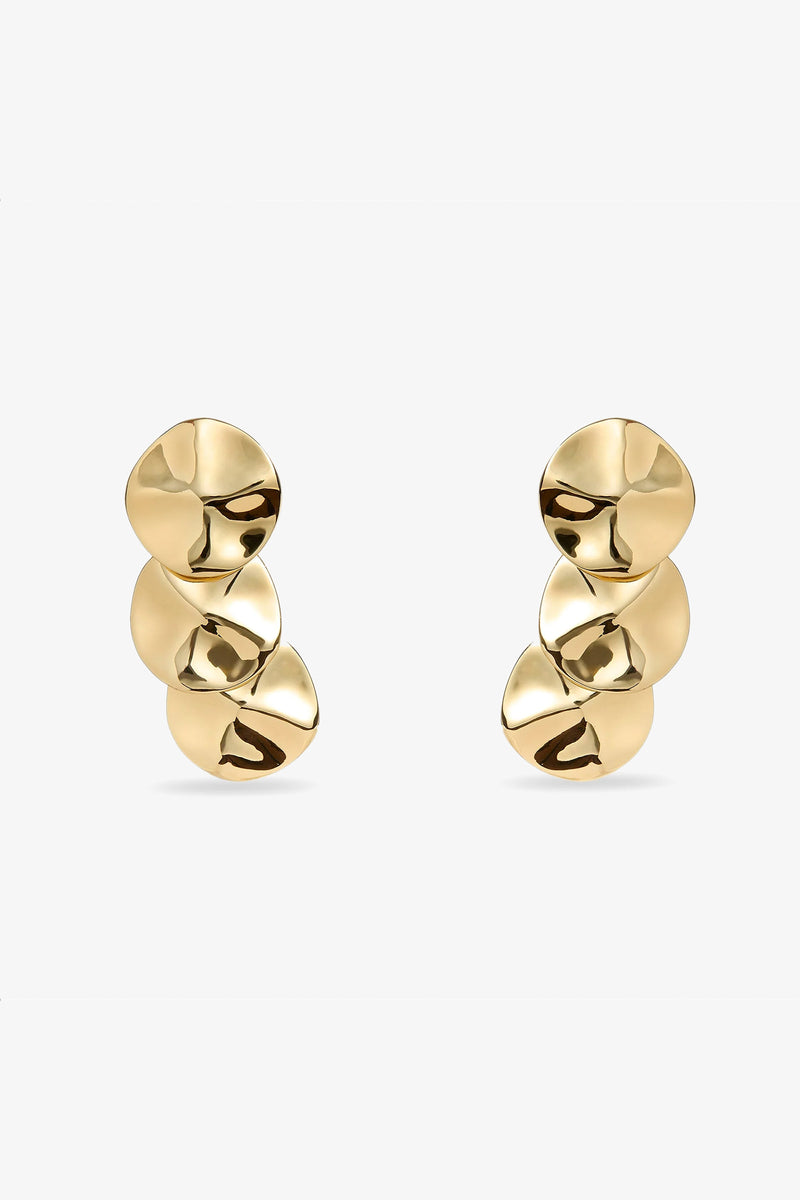 The Socialite Statement Earrings feature three gold, disc-shaped pieces with a shiny, slightly hammered finish arranged vertically against a plain white background.