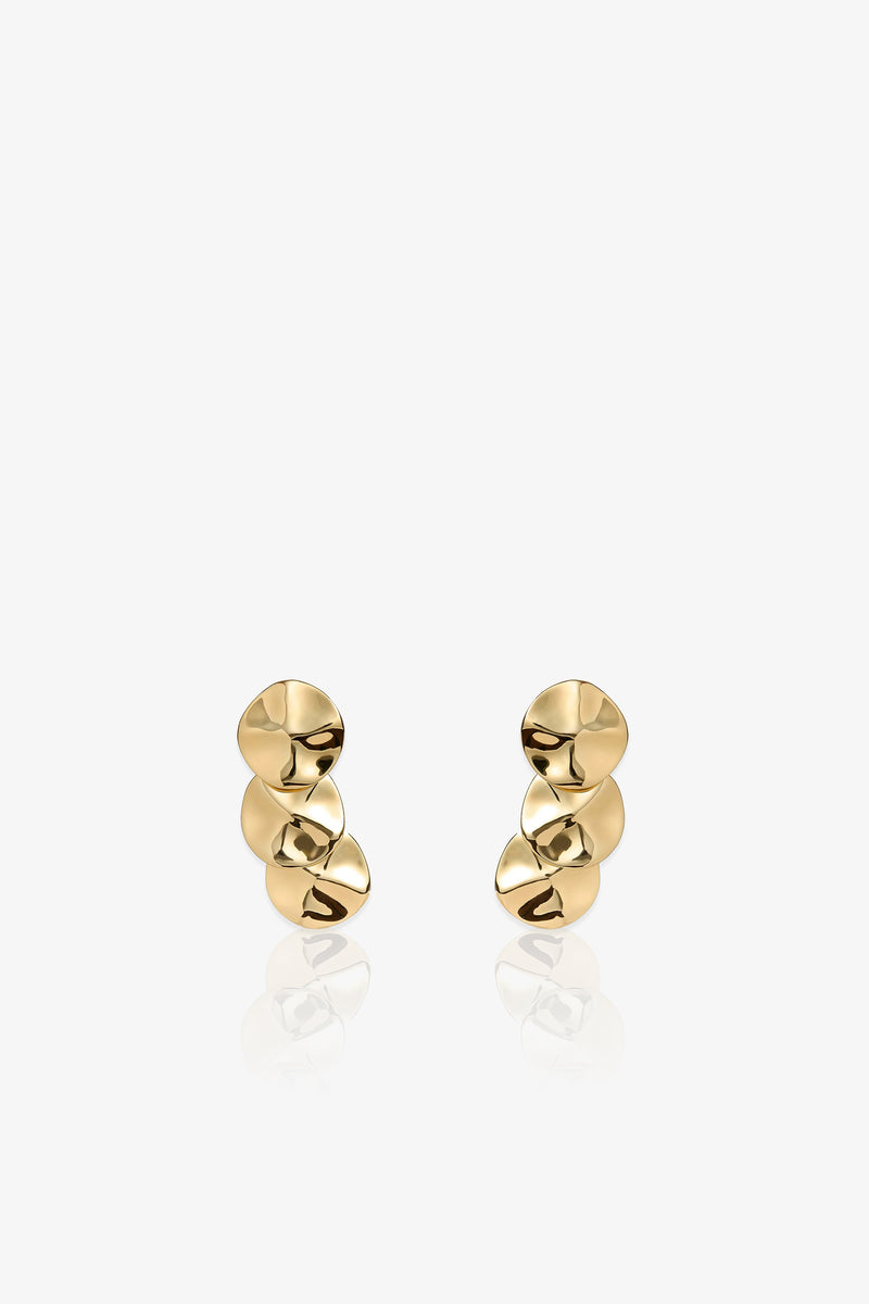 A pair of Socialite Statement Earrings, each featuring three irregular, disc-shaped gold pieces stacked vertically, displayed against a plain white background.