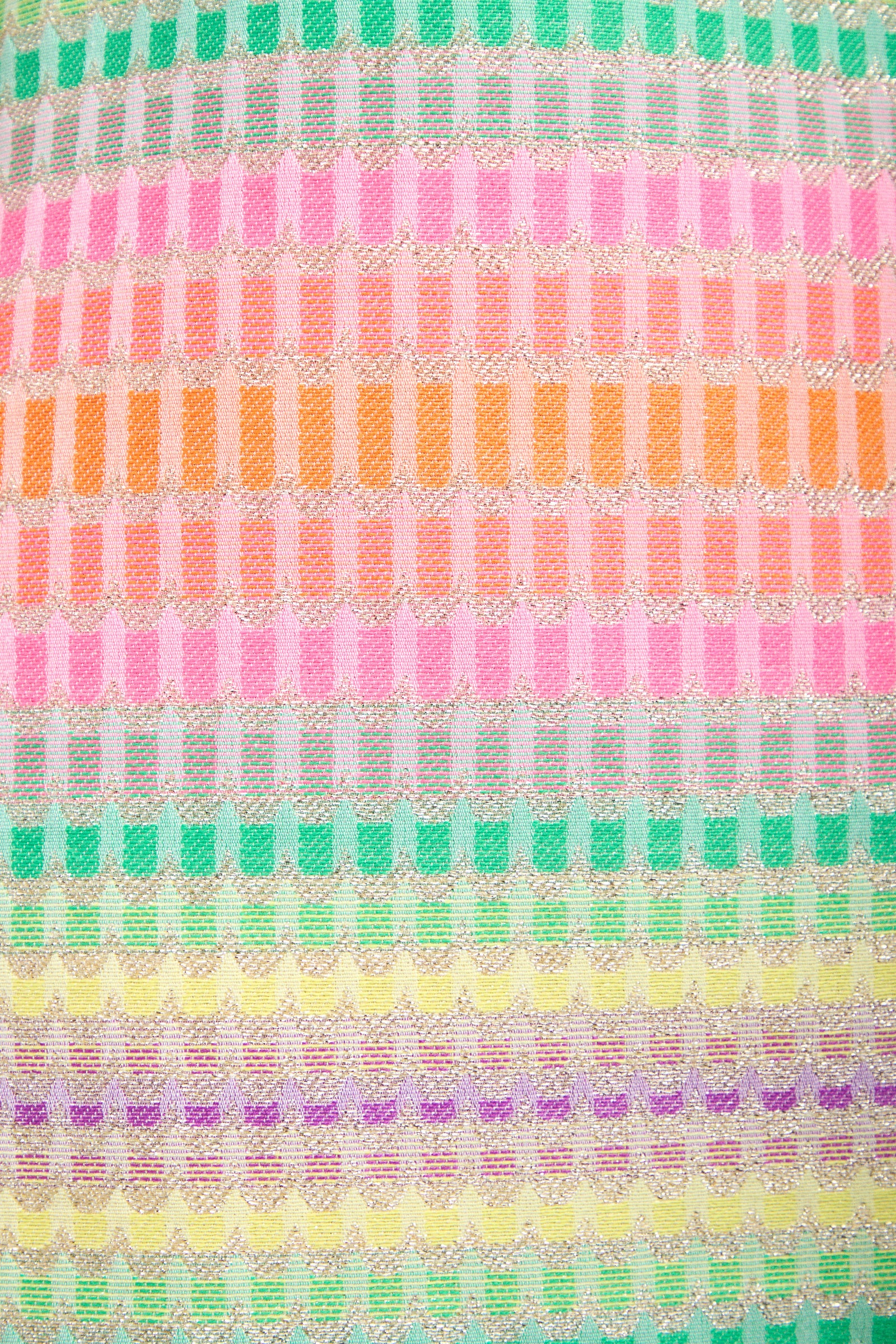 The Aspire Dress features a colorful abstract pattern with horizontal rows of geometric rectangular and scalloped shapes in green, pink, orange, yellow, and purple on a light background.