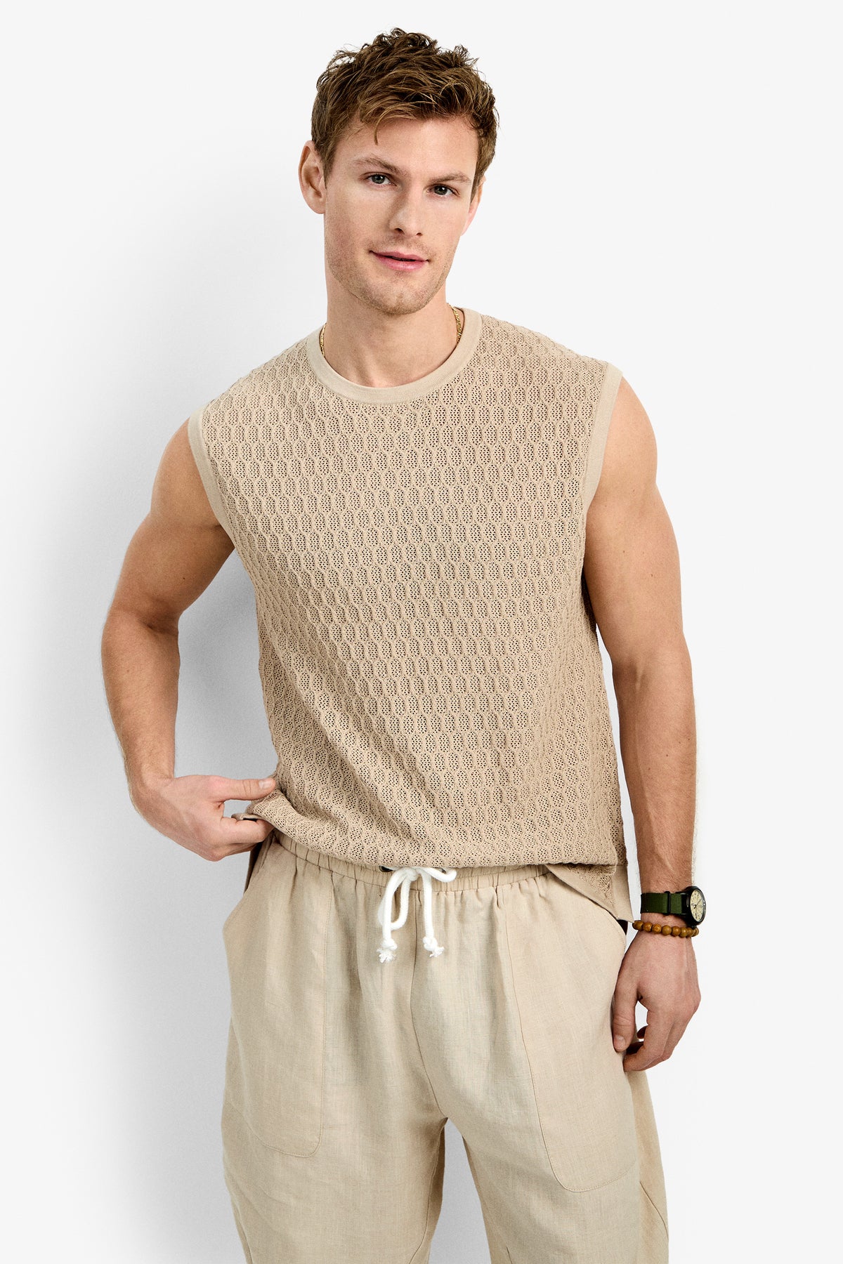 A man wearing the Tovey Mesh Tan stands against a plain white background, looking at the camera with a relaxed expression.
