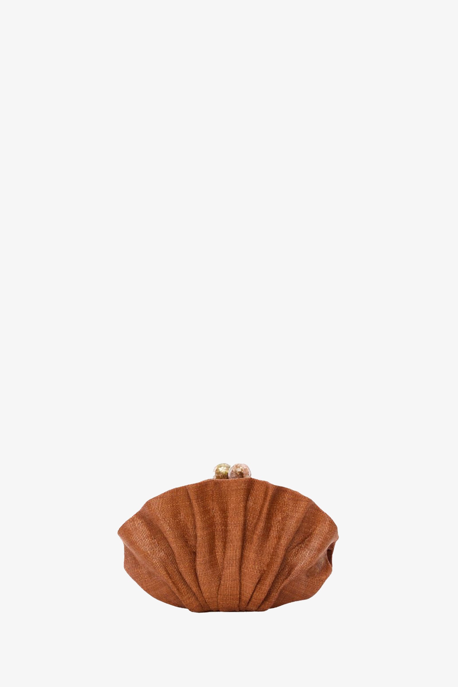 The Origami Scallop Clutch in cocoa features a small, shell-shaped design with a pleated texture and round gold clasps, shown against a plain white background.