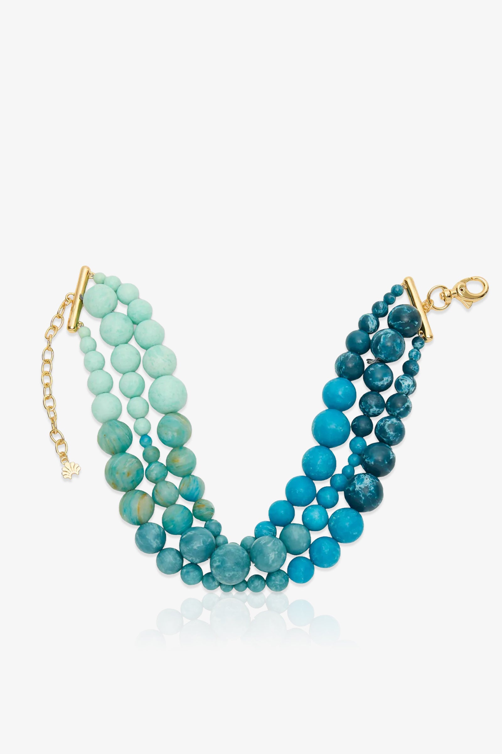 Riviera Diana Triple Row Necklace with round beads in gradient shades of turquoise blue, featuring gold-tone metal clasps and an adjustable chain.