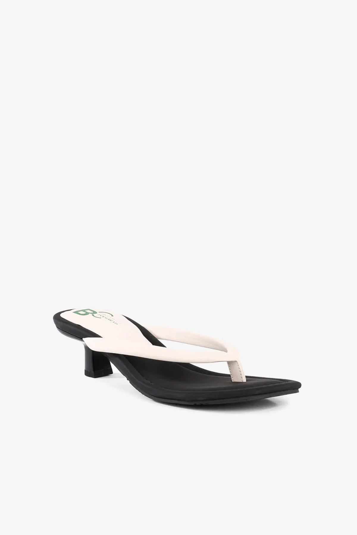 The Riptide Sandal, featuring white thong straps and a small heel, is displayed on a white background and angled slightly to the left.