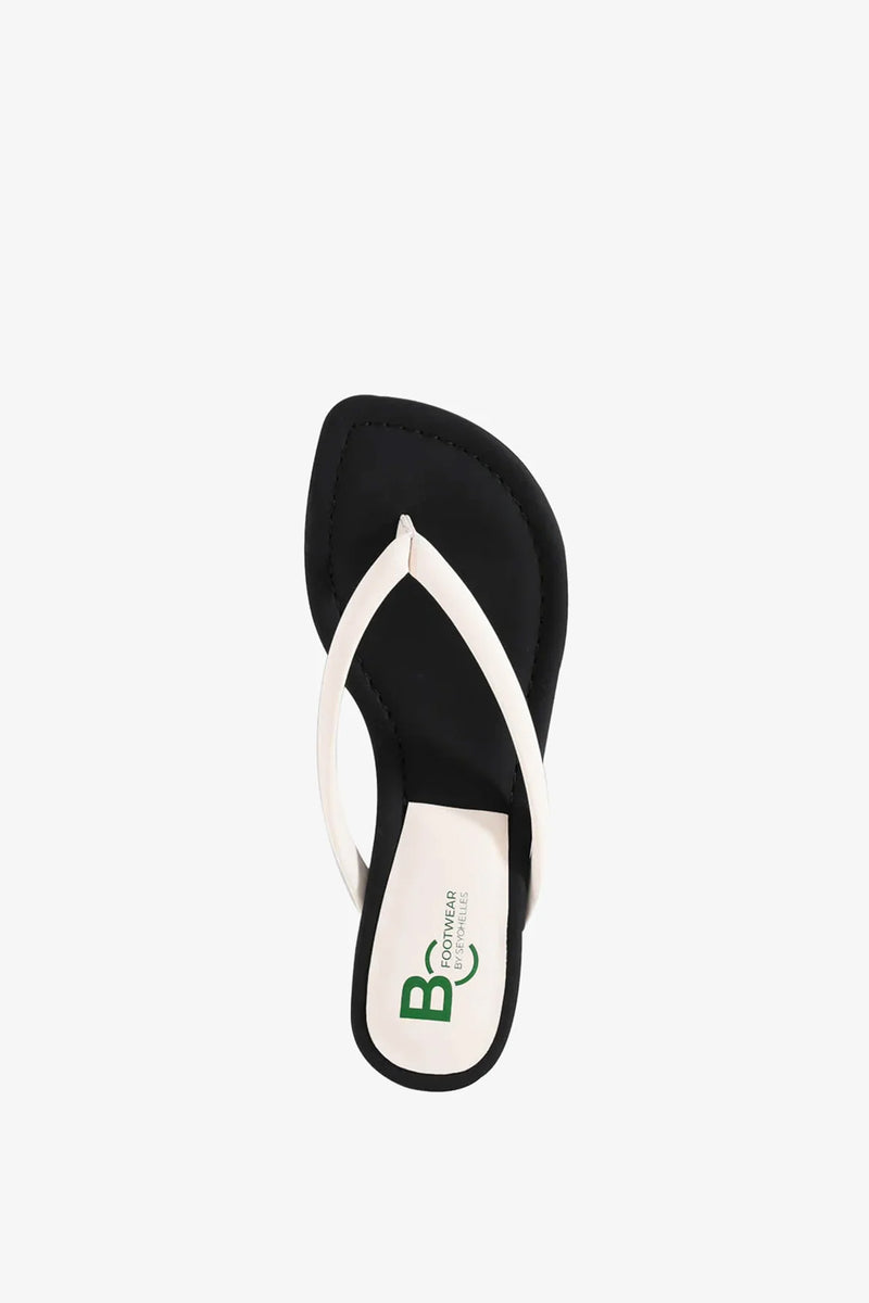A single Riptide Sandal in black with a white thong strap, viewed from above on a plain white background. The insole features a green and black BO logo printed near the heel.