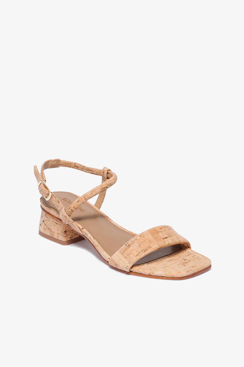 The Josei Low Heel Sandal features a cork-textured design with a low block heel, open toe, ankle strap, and buckle closure, displayed against a plain white background.
