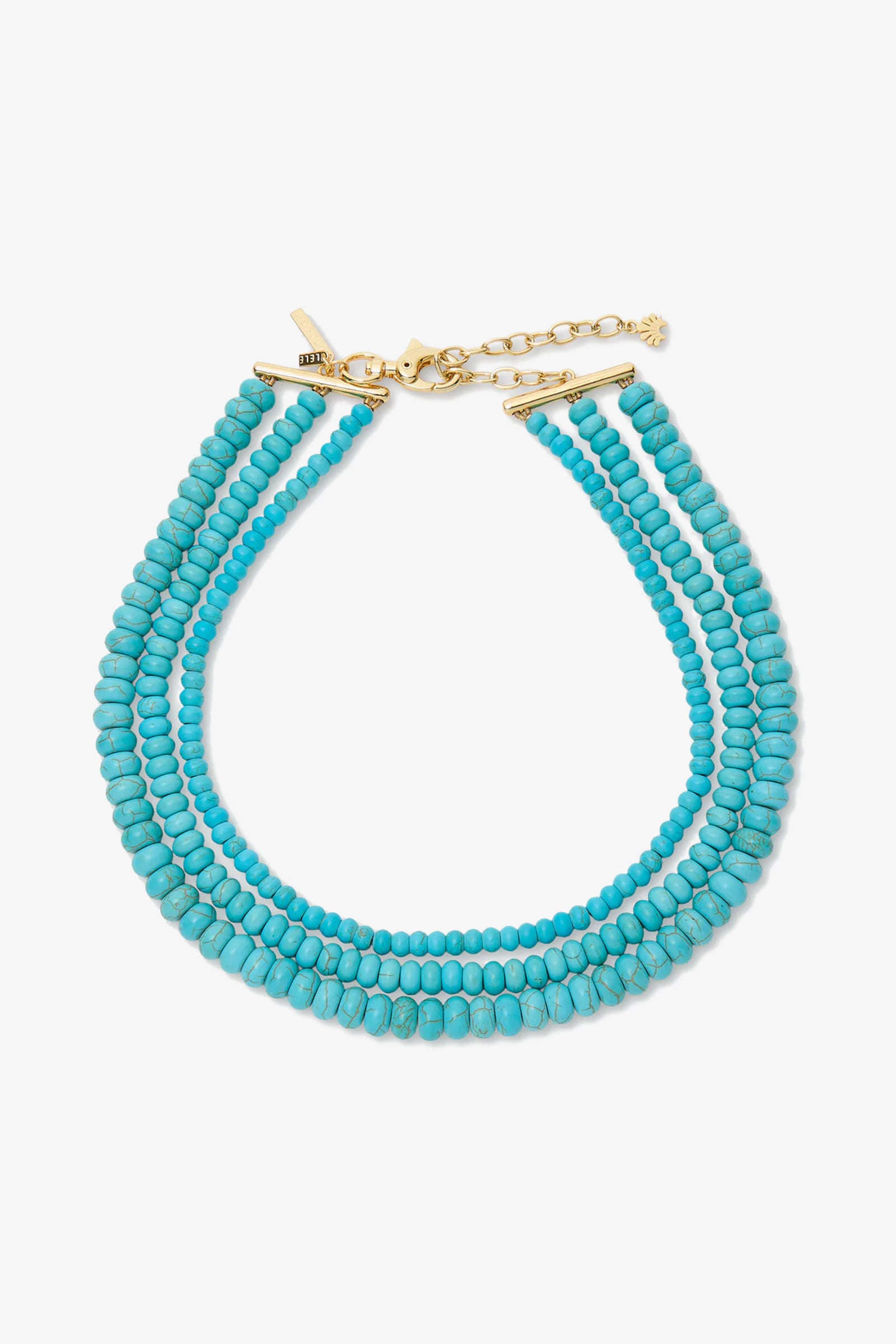 The Turquoise Multi Strand Necklace features three strands of small round turquoise beads with a gold clasp and extender chain, displayed on a white background.