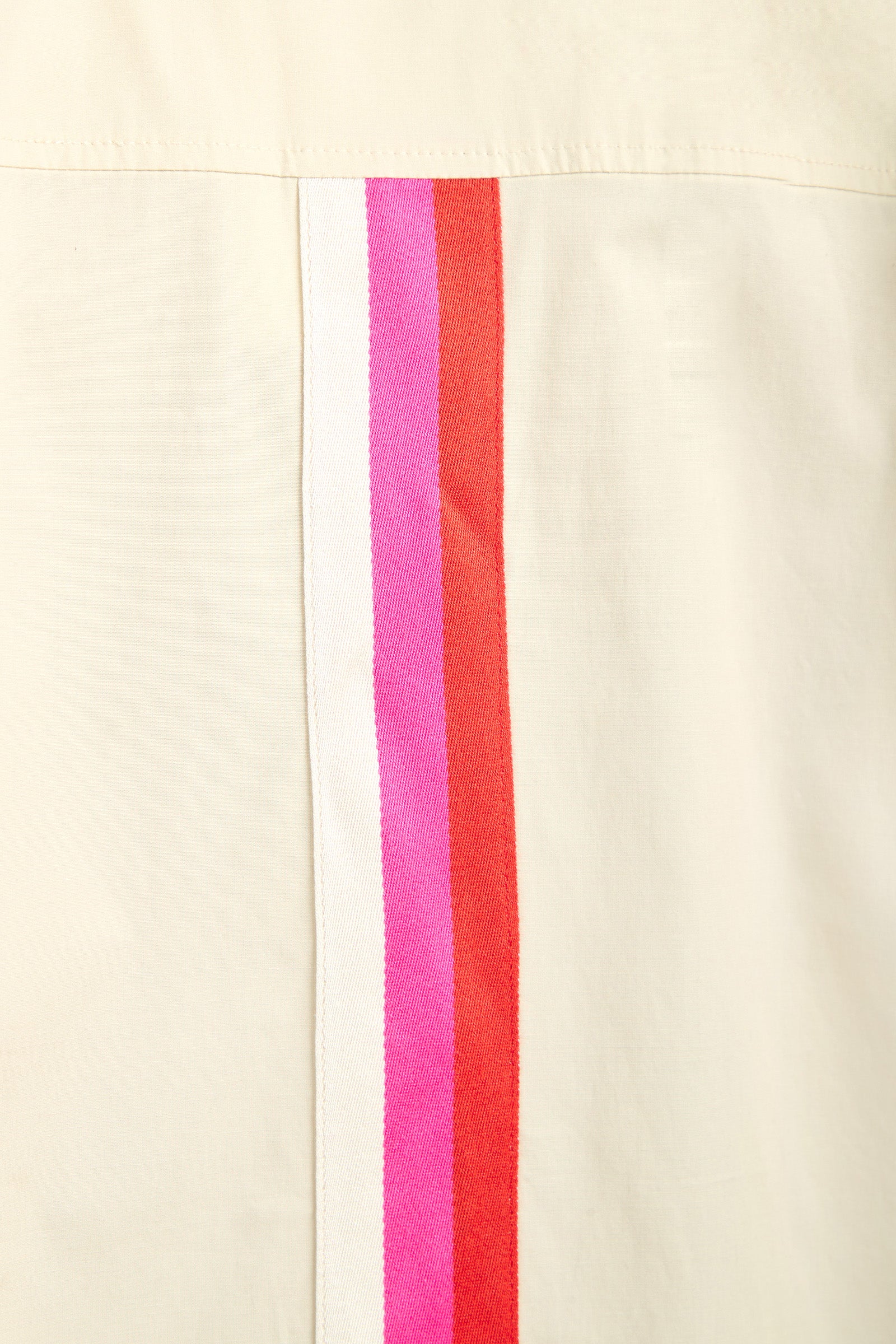 The OPPONENT DRESS features a cream-colored fabric with three closely spaced vertical stripes—white, pink, and red—running parallel along the seam.