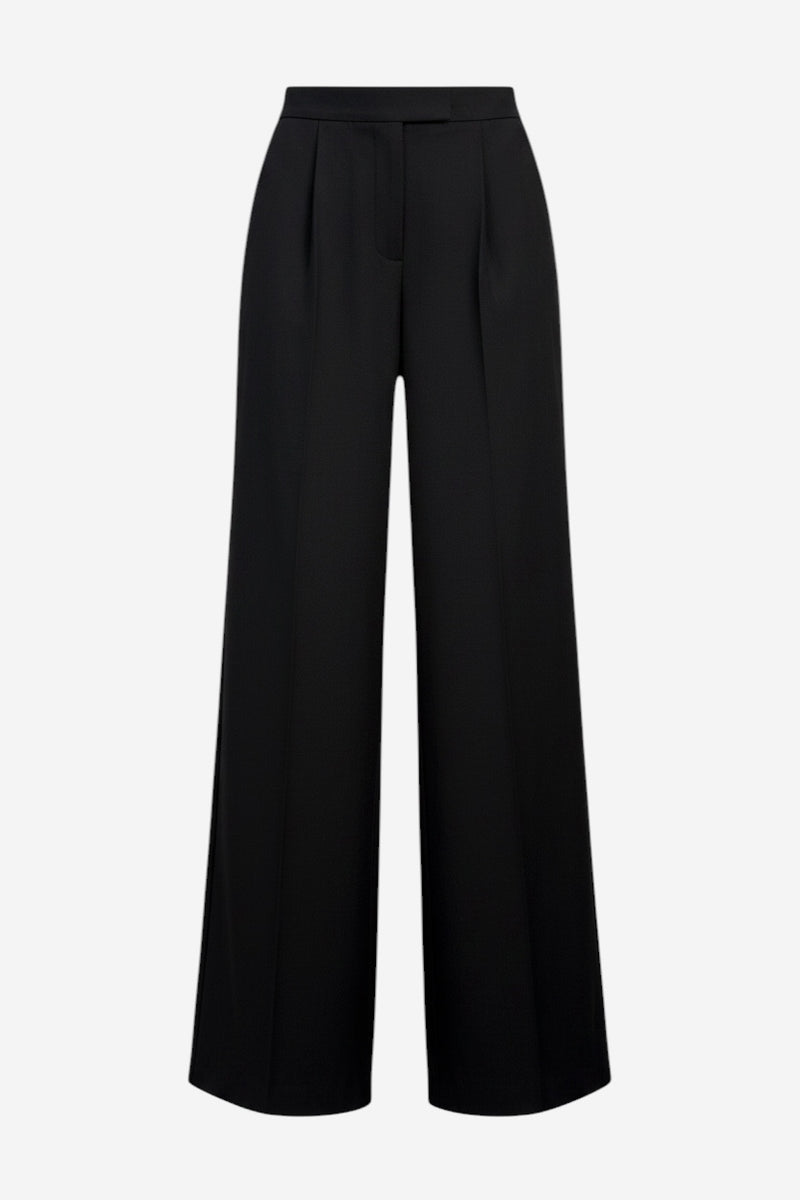 The Mimmo Pant is a pair of black, high-waisted, wide-leg dress pants featuring front pleats, belt loops, and a concealed closure, shown against a plain white background.