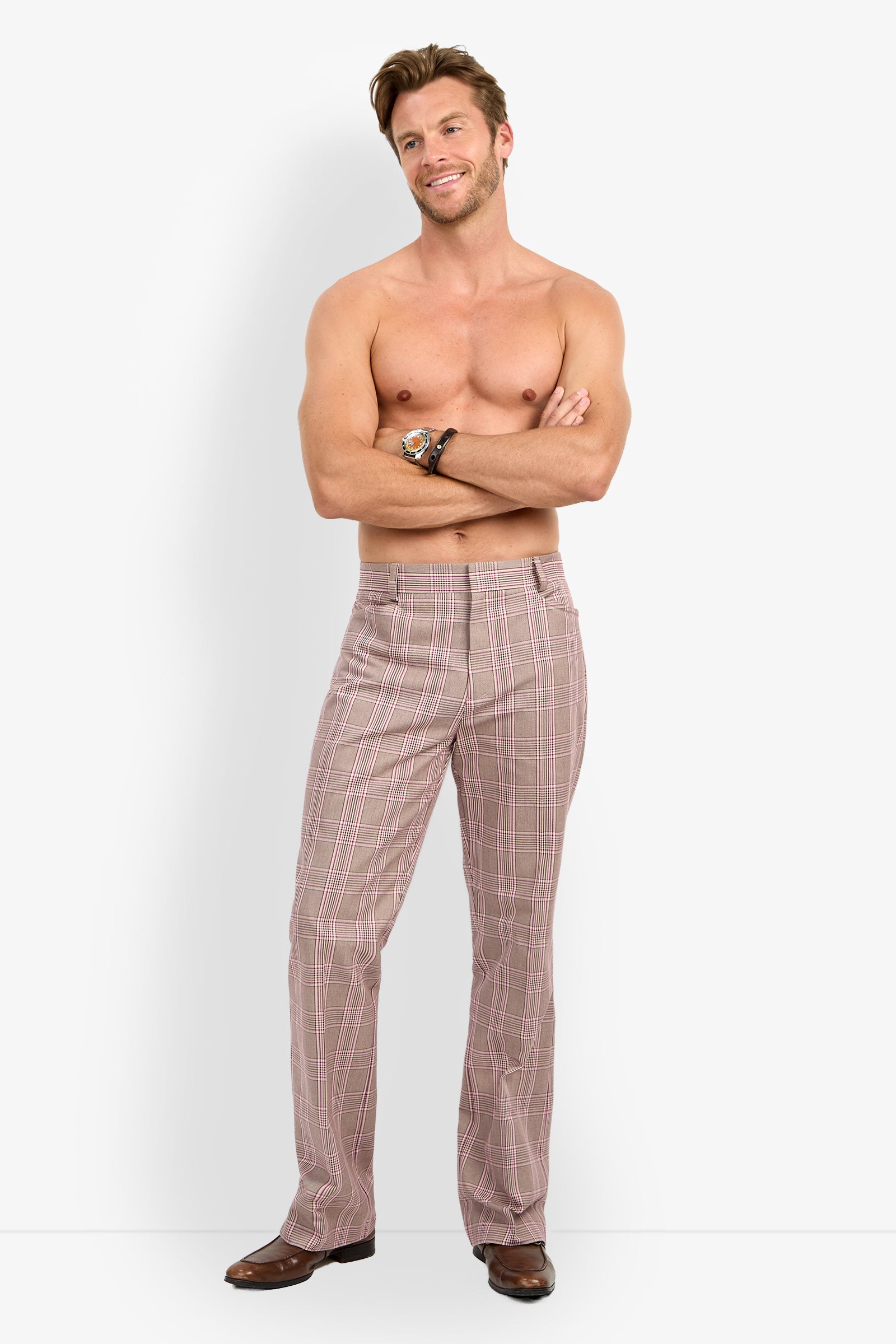 A shirtless man stands with his arms crossed, smiling at the camera while wearing the Alejandro Bootleg Trouser and brown shoes against a plain white background.