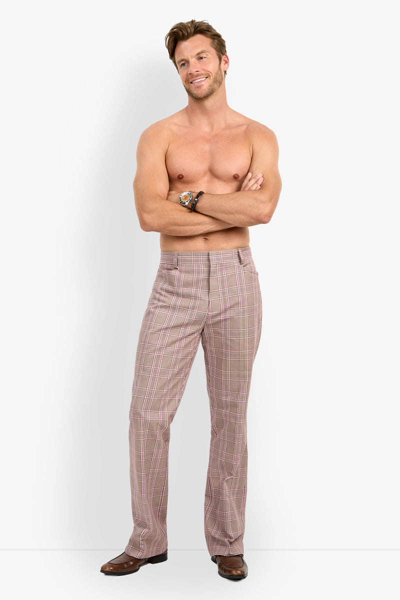 A shirtless man stands with his arms crossed, smiling at the camera while wearing the Alejandro Bootleg Trouser and brown shoes against a plain white background.