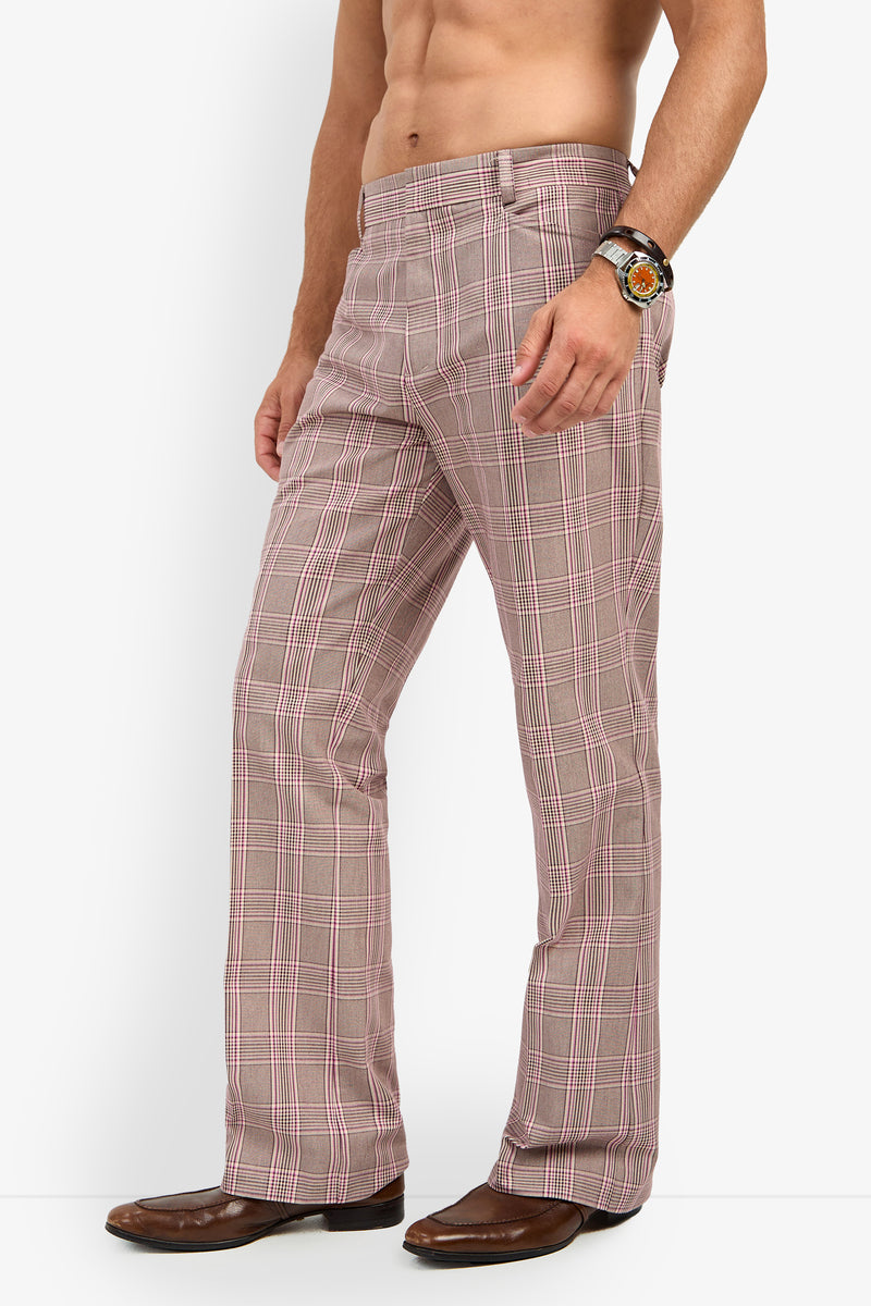A shirtless person wearing the Alejandro Bootleg Trouser—pink plaid flared pants—paired with brown shoes and a wristwatch, standing against a white background.
