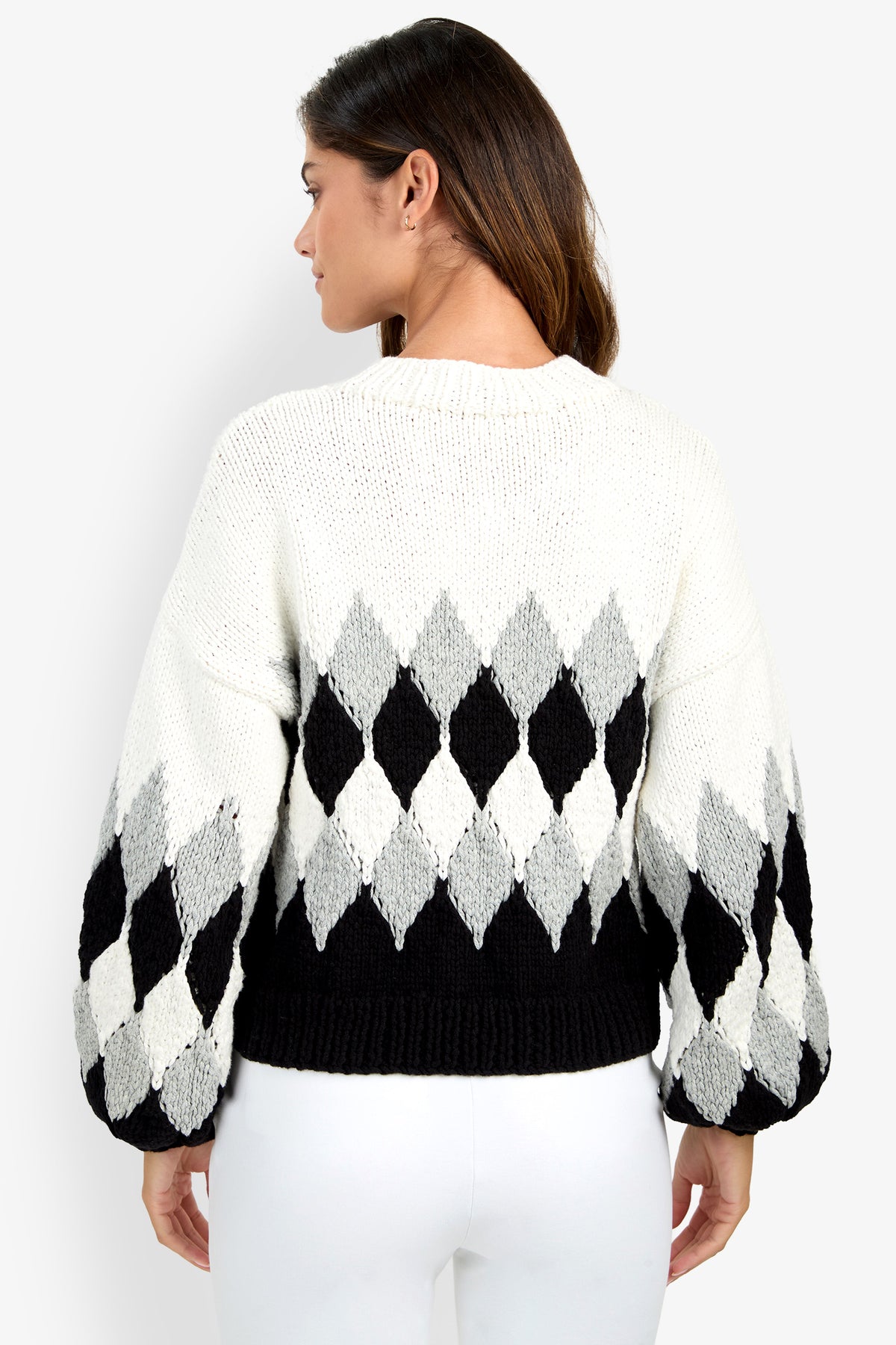 A woman wearing a white, black, and gray argyle-patterned Cavallari Sweater viewed from the back.