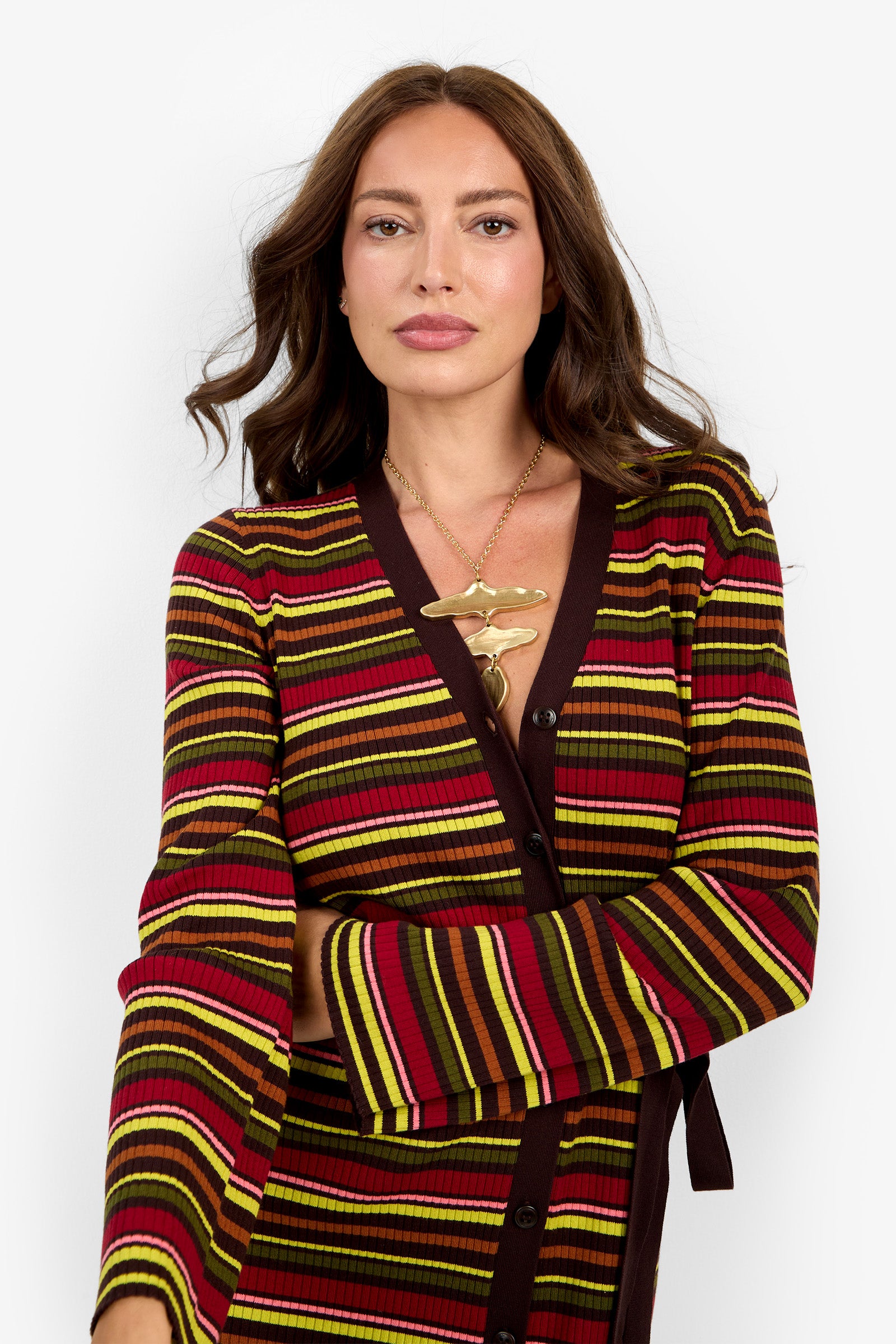 A woman with long brown hair wears the Mercer Sweater Dress, posing against a plain white background.
