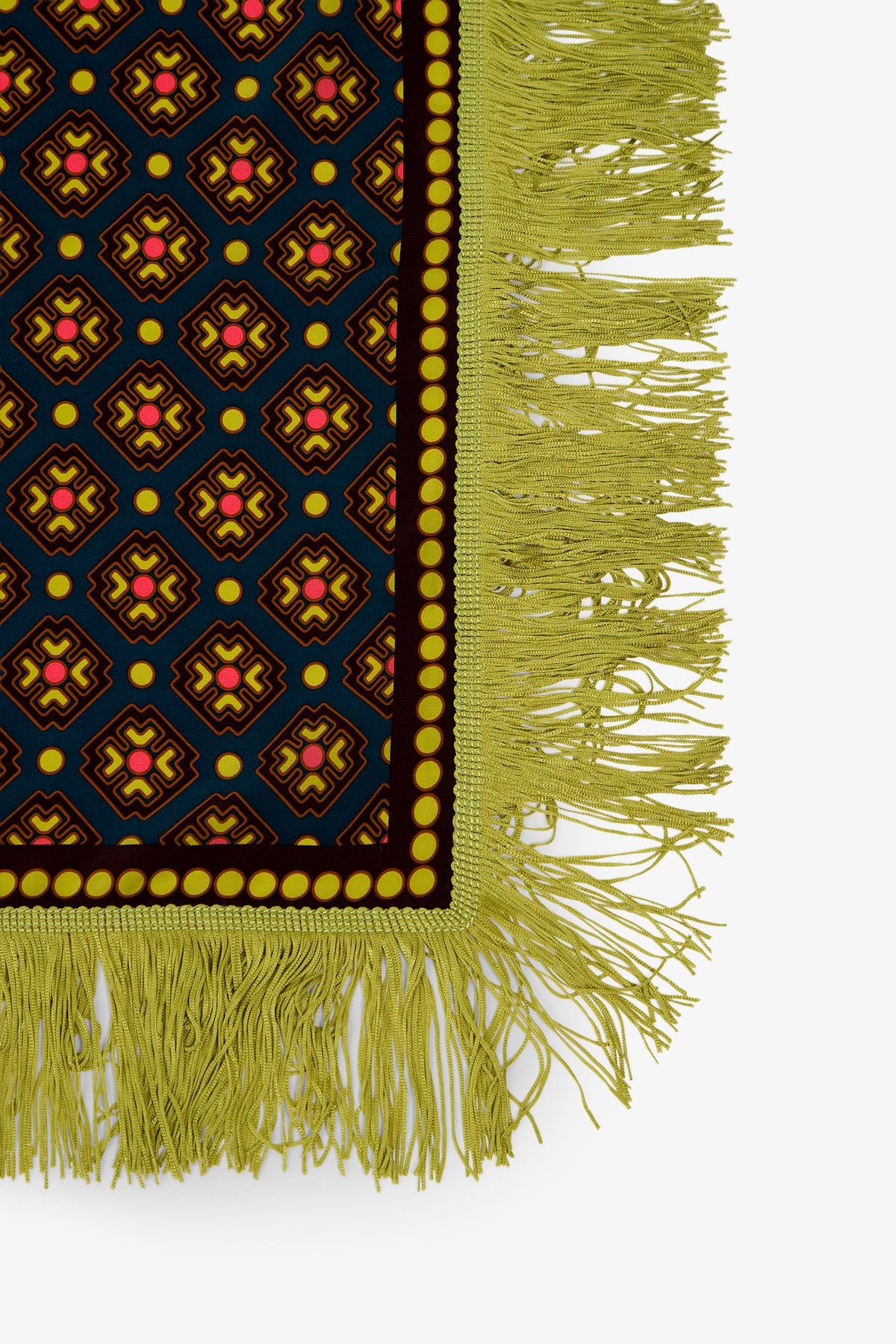 A section of the Foulard Scarf shows a geometric design in blue, yellow, red, and black with thick yellow fringe and a border of yellow dots along the edge.