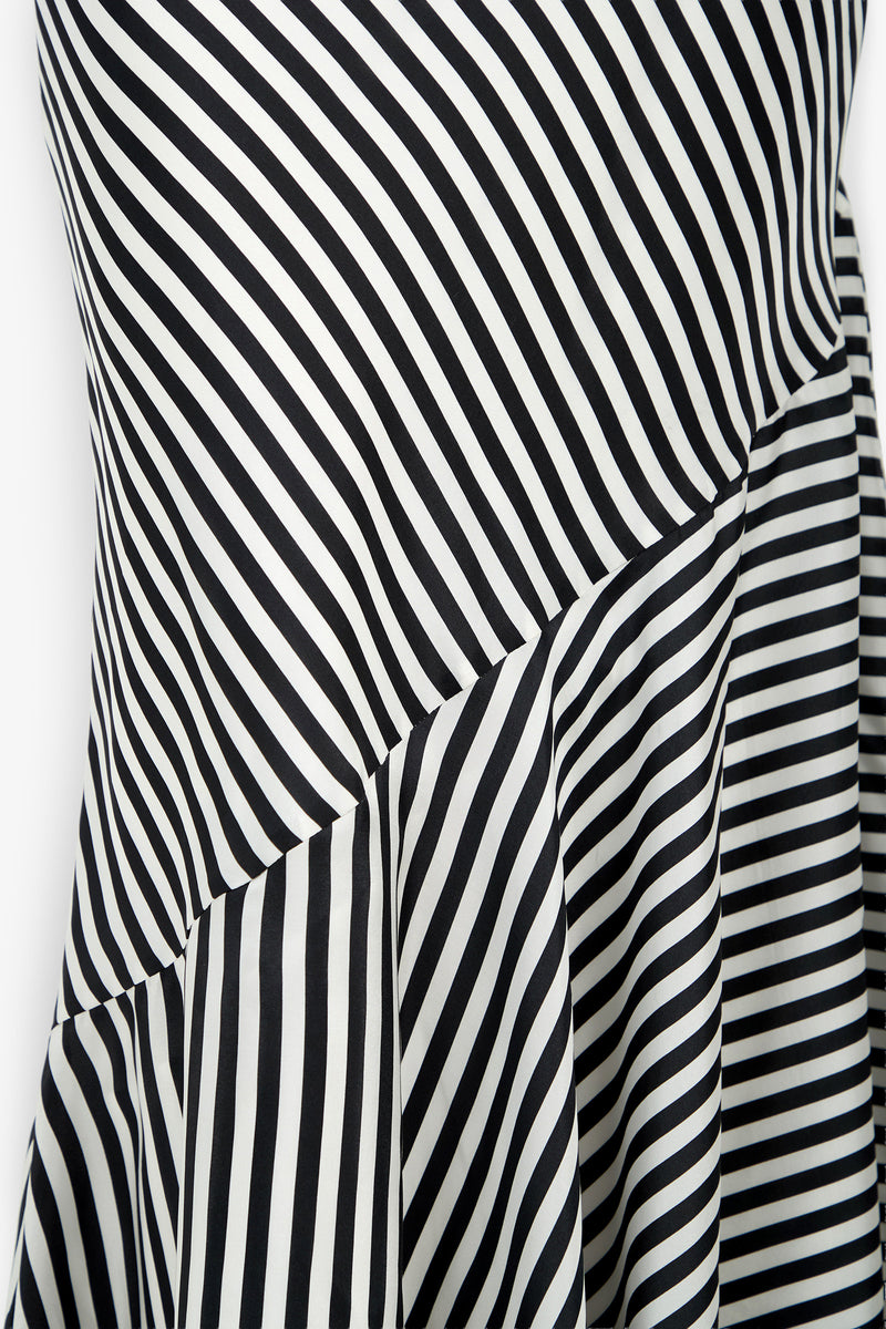 Close-up of the Lady Dress featuring black and white striped fabric, where diagonal, vertical, and horizontal lines intersect to create a bold, geometric pattern.