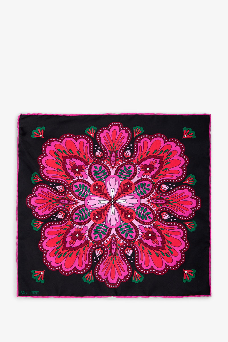The Sautoir Silk Pocket Square in MULTI features a vibrant pink, magenta, and red symmetrical floral pattern on a black background, highlighted with touches of green and white. Its intricate design creates a kaleidoscopic effect.