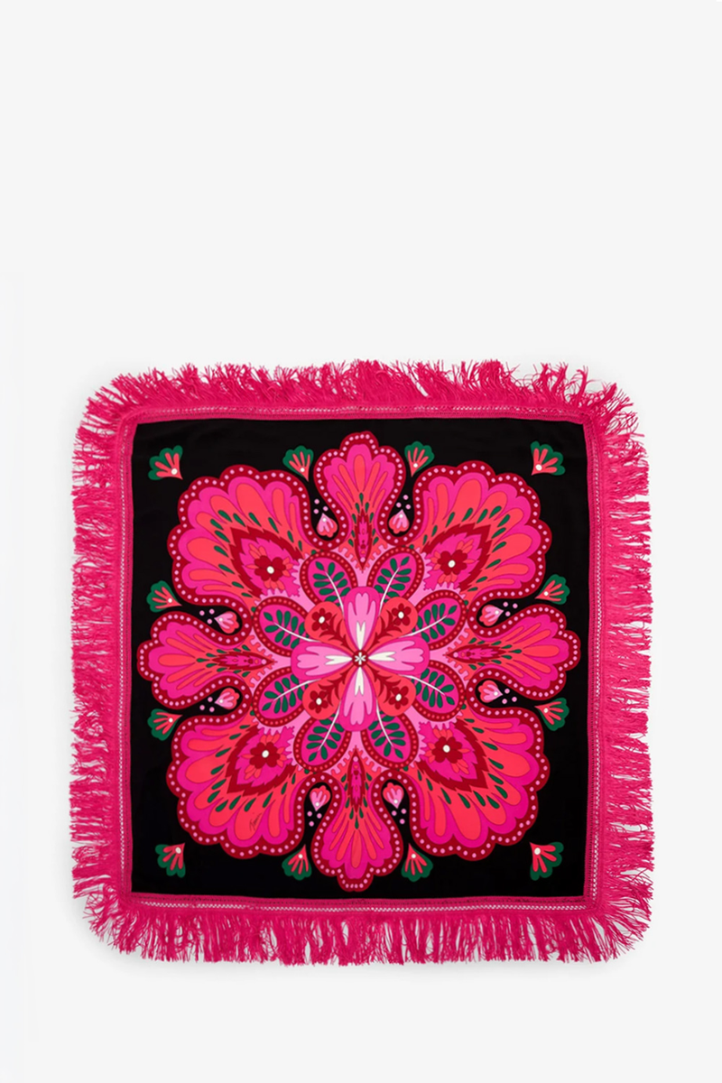 Introducing the Sautoir Fringe Scarf: a square black scarf featuring a vibrant pink and red floral mandala design, highlighted by green and white accents. Finished with a bold pink fringe border on all sides.