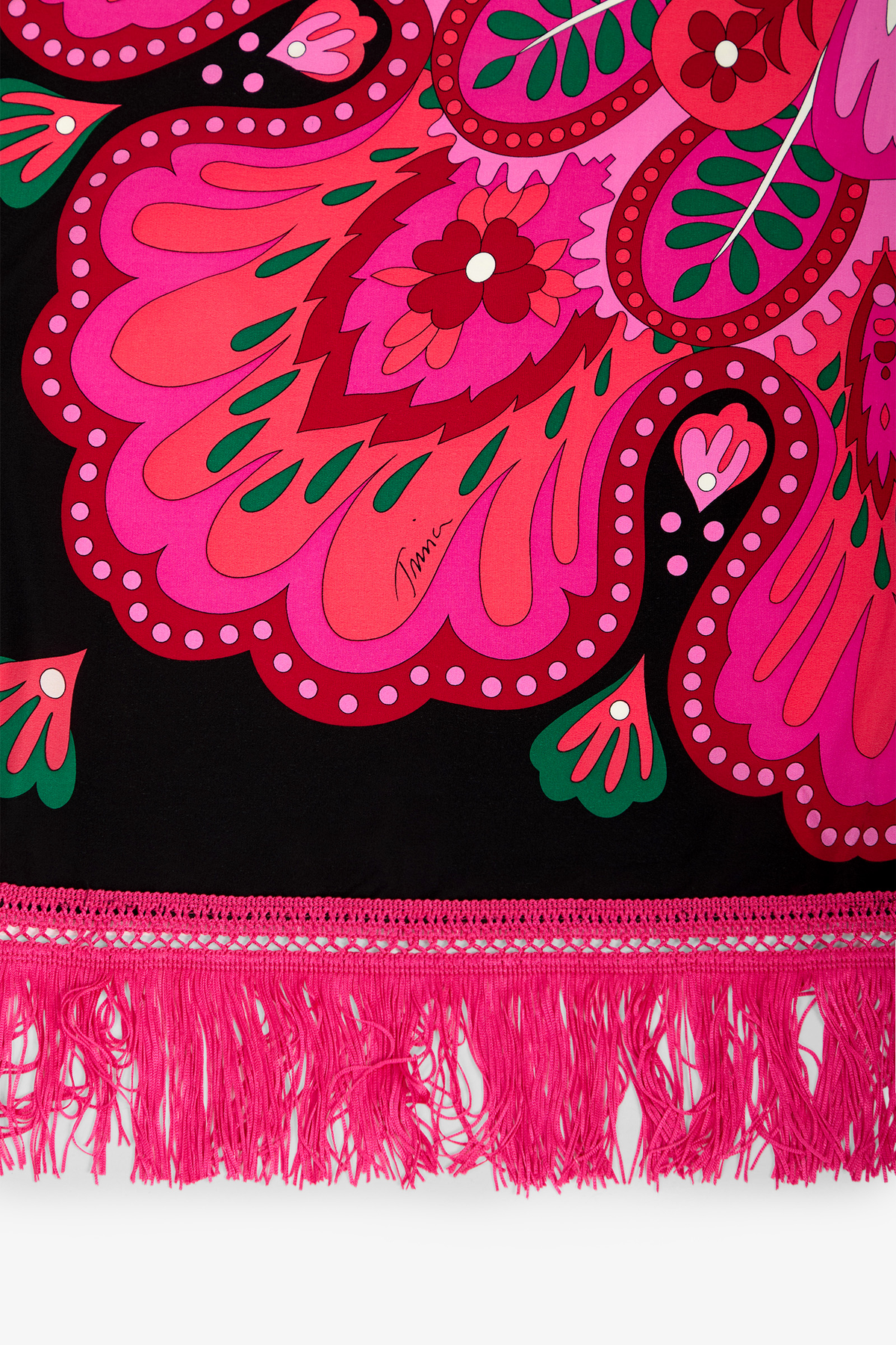 Introducing the Sautoir Silk Scarf, featuring vibrant pink and red paisley patterns on a black background with green accents and a pink fringed edge. The designer’s signature is elegantly incorporated within the design.