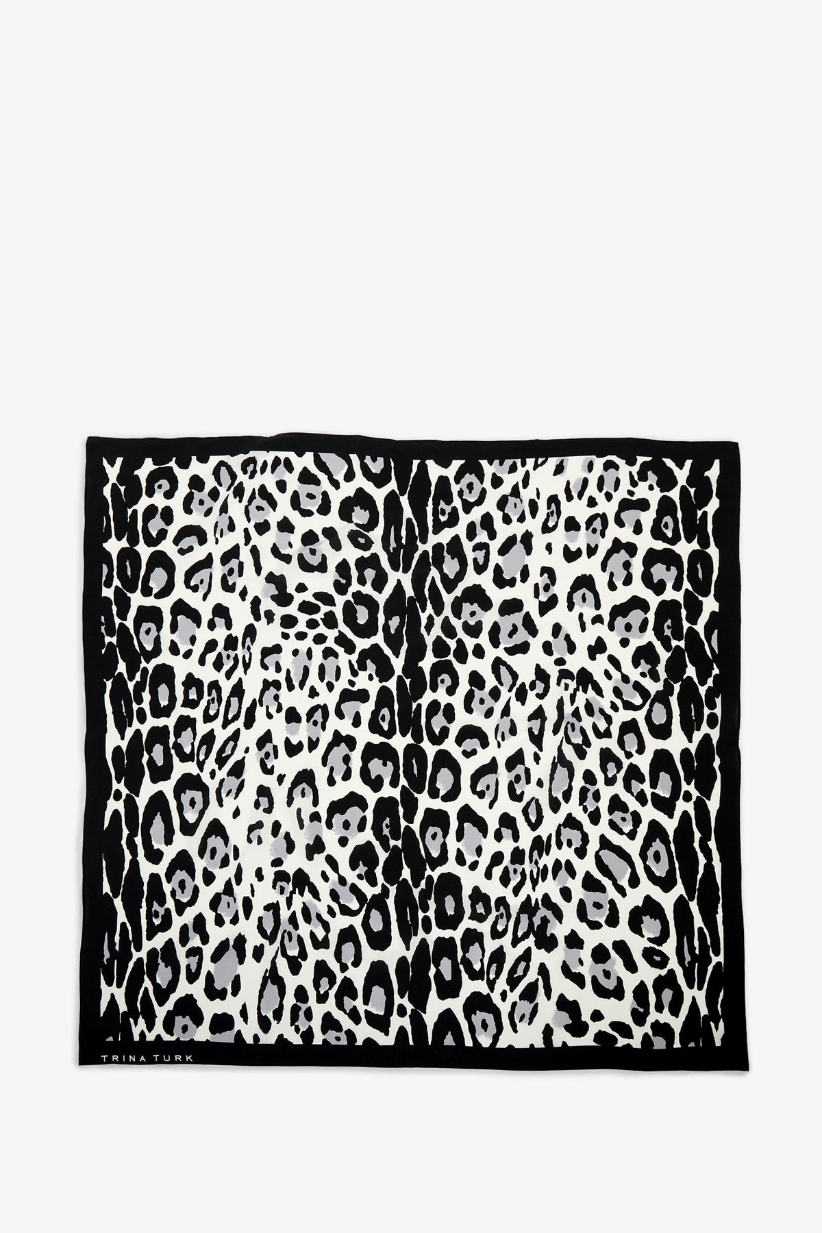 The Snow Leopard Silk Scarf is a rectangular accessory featuring a black and white leopard print pattern framed by a solid black border.