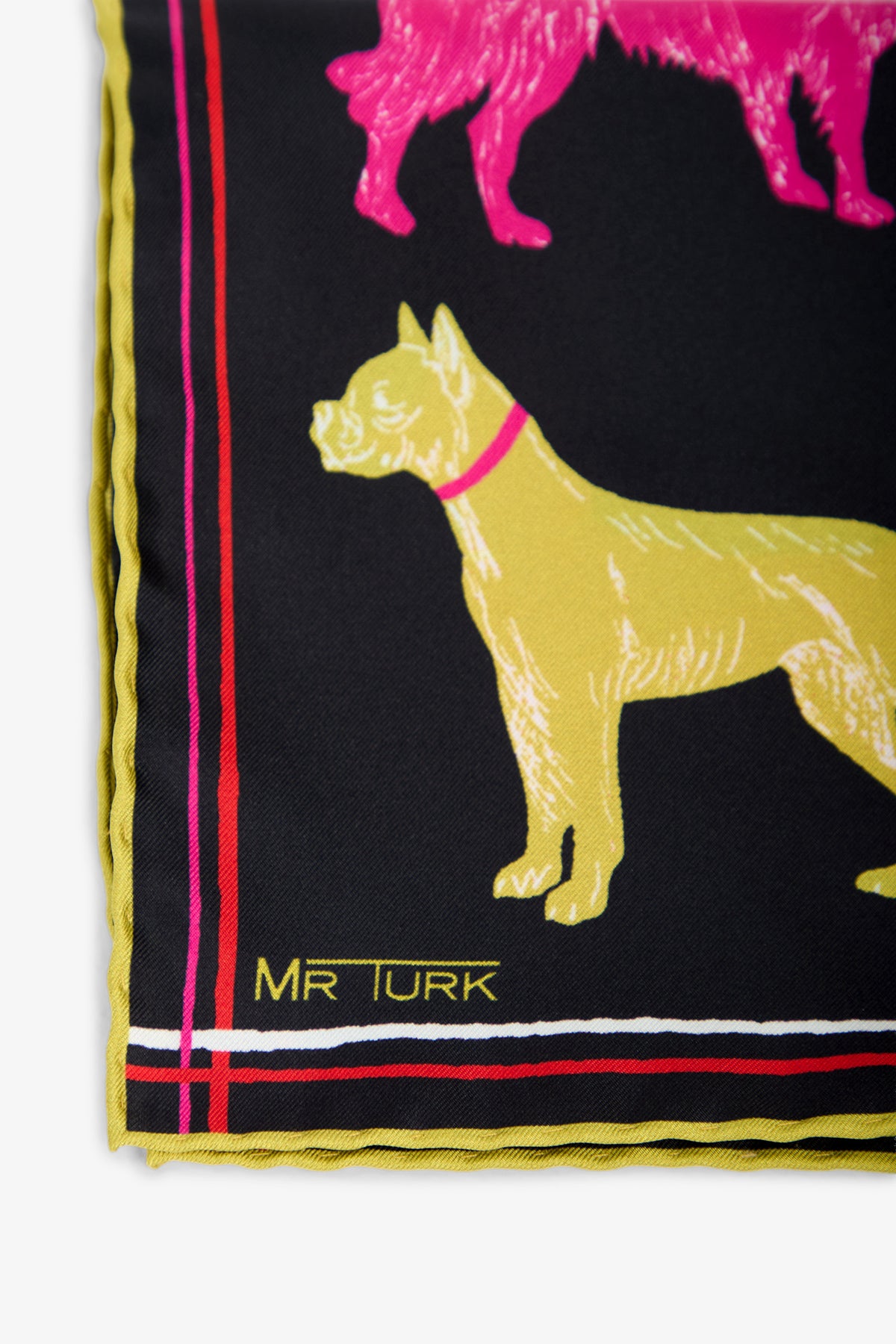 Close-up of a corner of the Dogs Silk Pocket Square, showcasing a yellow dog illustration, a pink dog above it, yellow scalloped edging, red and pink stripes, and the text MR TURK printed near the bottom.