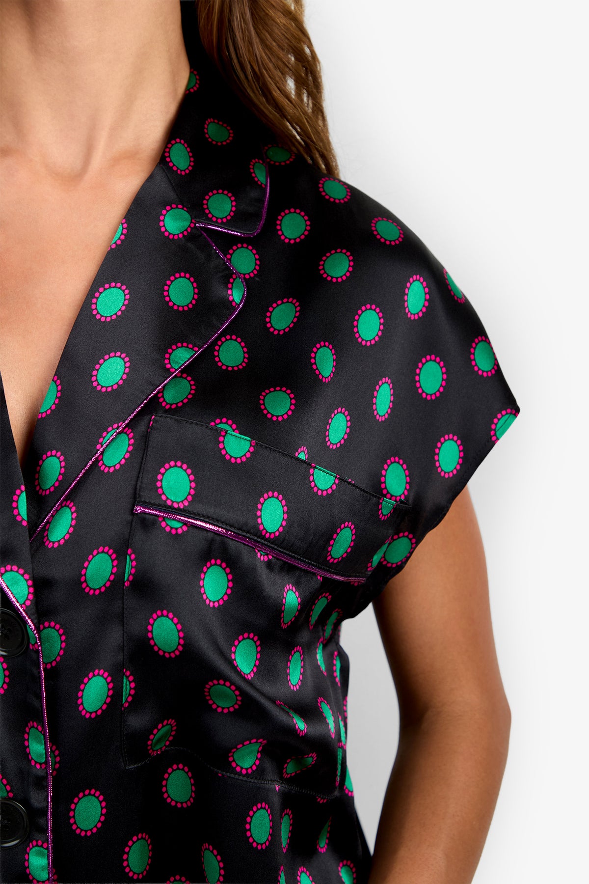 ADARA 2 TOP: short-sleeved silk button-down in black with a green and magenta circular pattern and magenta piping on the collar and pocket.